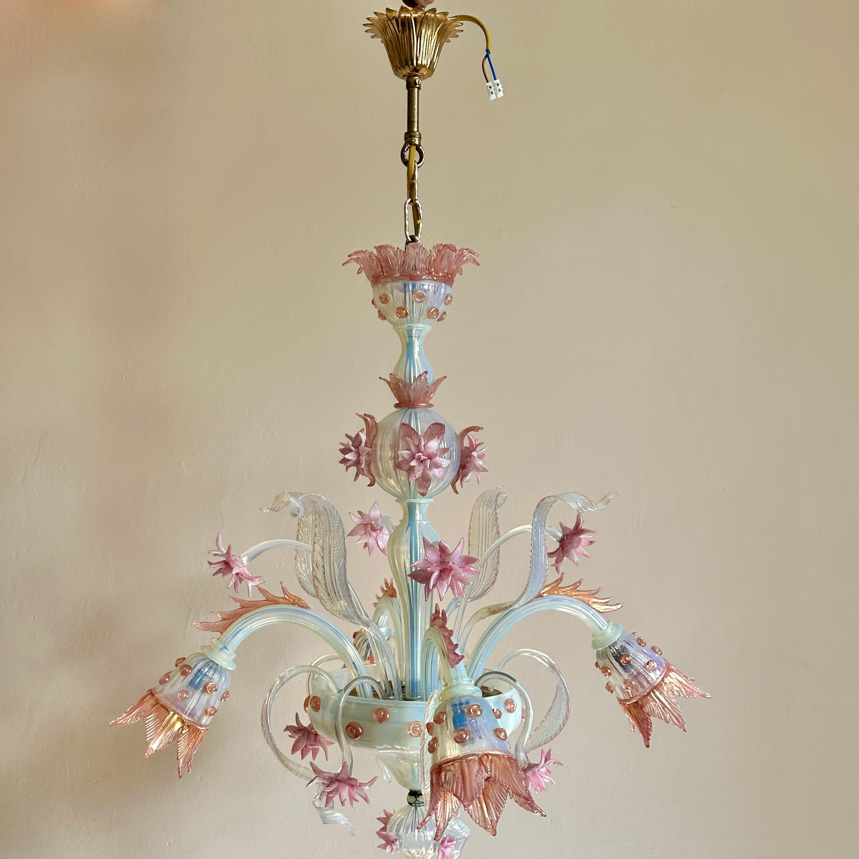 Early C20th Murano opaline glass chandelier.

Exceptional four-arm, handblown glass ceiling light circa 1905. Made by the celebrated Salviati family. In excellent condition with no missing, chipped or repaired parts, the chandelier has been rewired