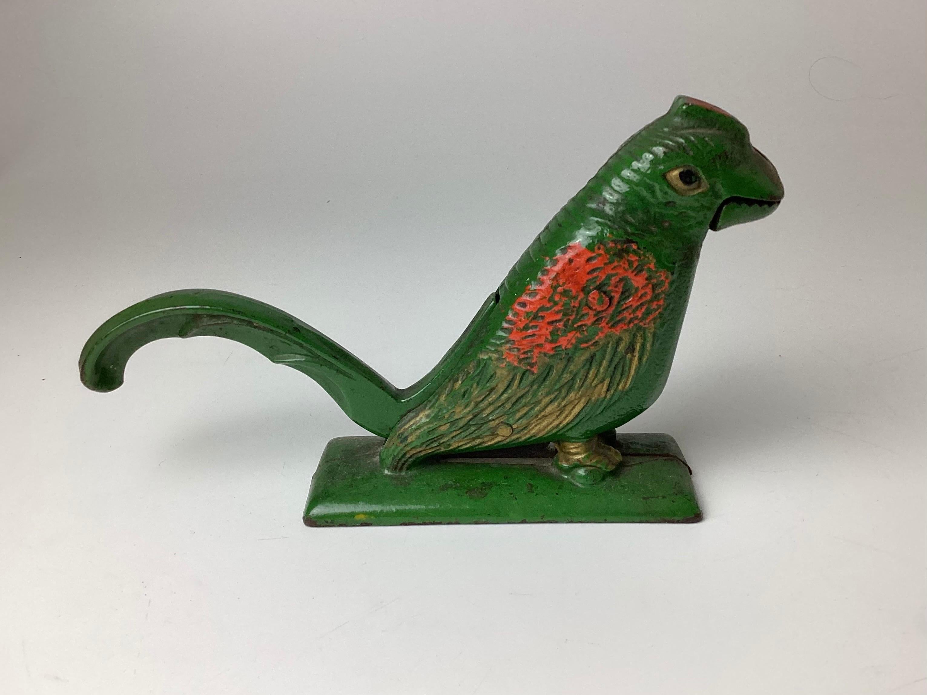 Early cast iron bird nut cracker in original paint. Mouth opens down to handle a large nut. Opens to 1 1/8