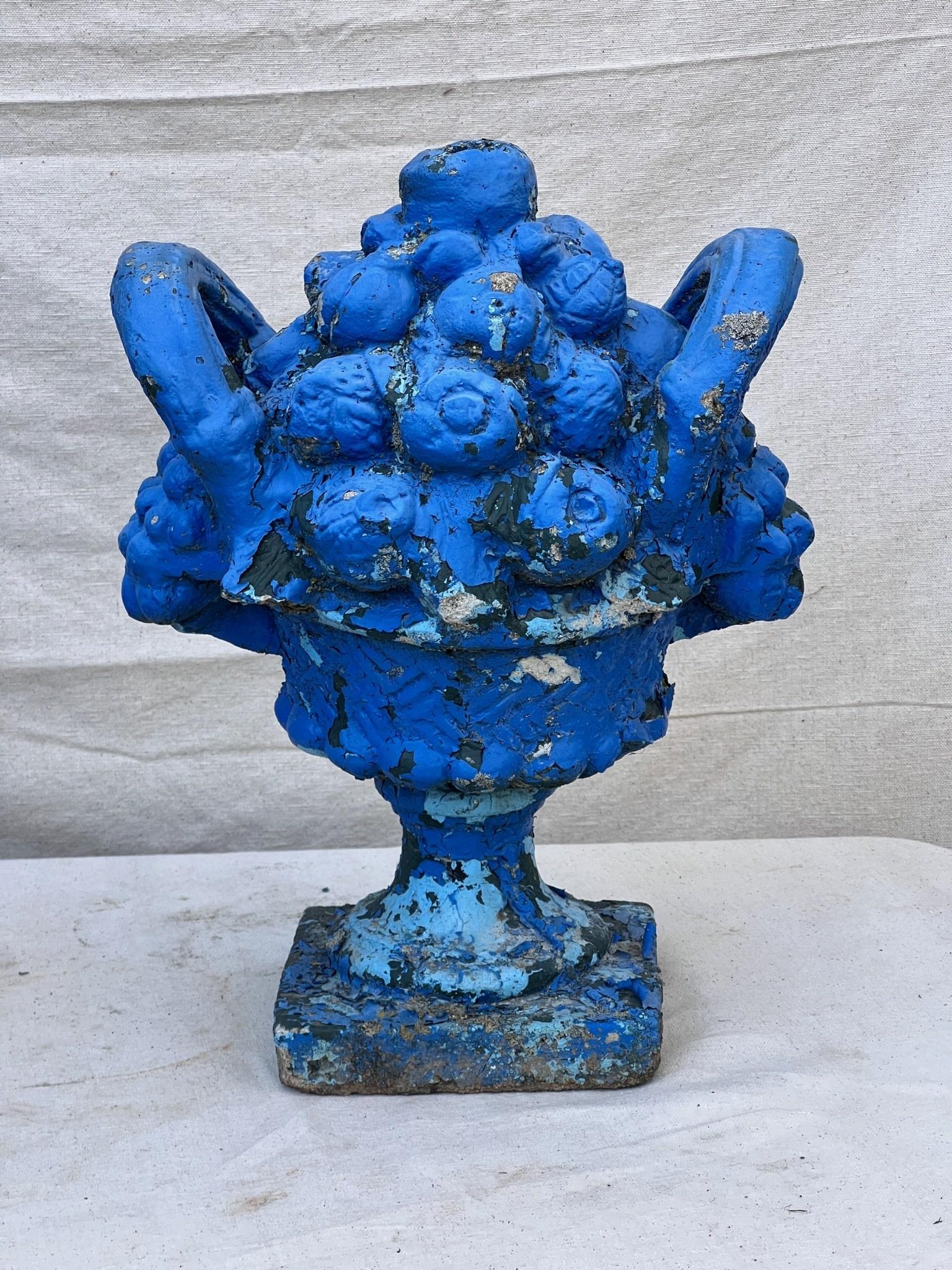 This meticulously crafted garden ornament showcases a captivating blue hue that carries an air of sophistication, while the skillful paint chipping across its body lends a naturally weathered allure, evoking the passage of time and the beauty of