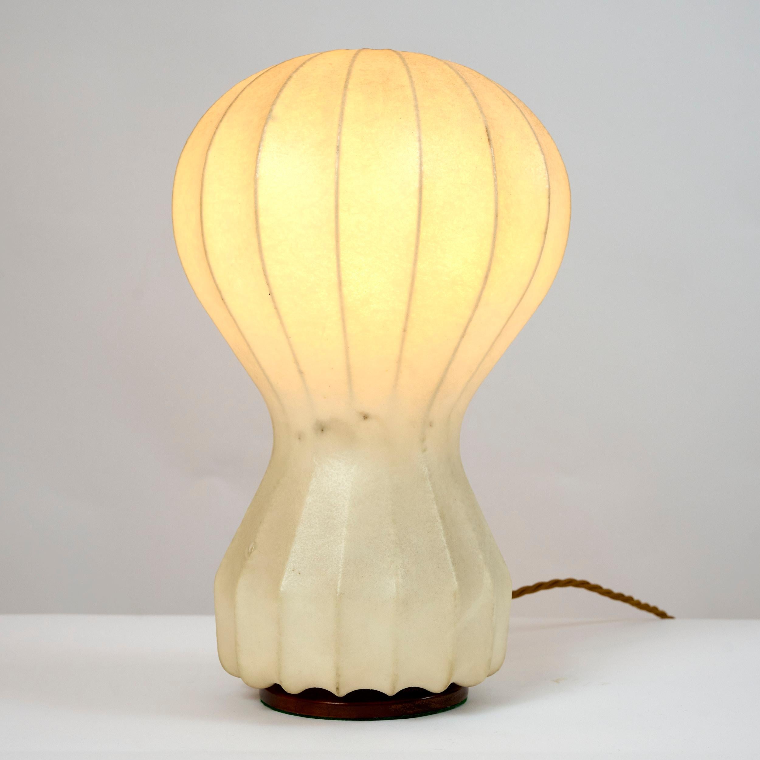 This is an early production Castiglioni 'Gatto' table light with a wooden base. 

Gives off a lovely diffused warm glow.

Another matching light is available. 

Fully re wired and functional.