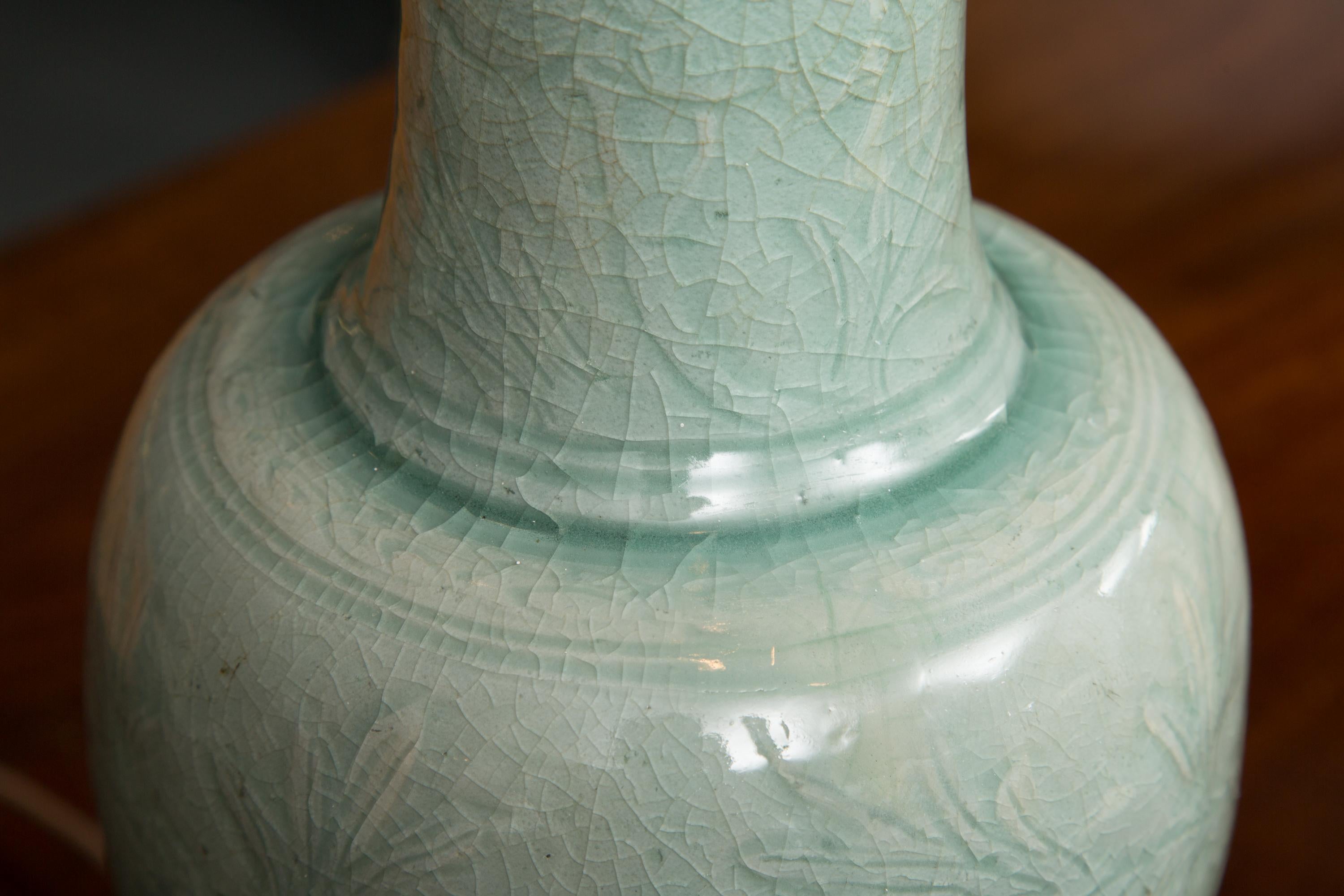 Chinese Celadon vase as a table lamp. The vase has a subtle relief pattern.