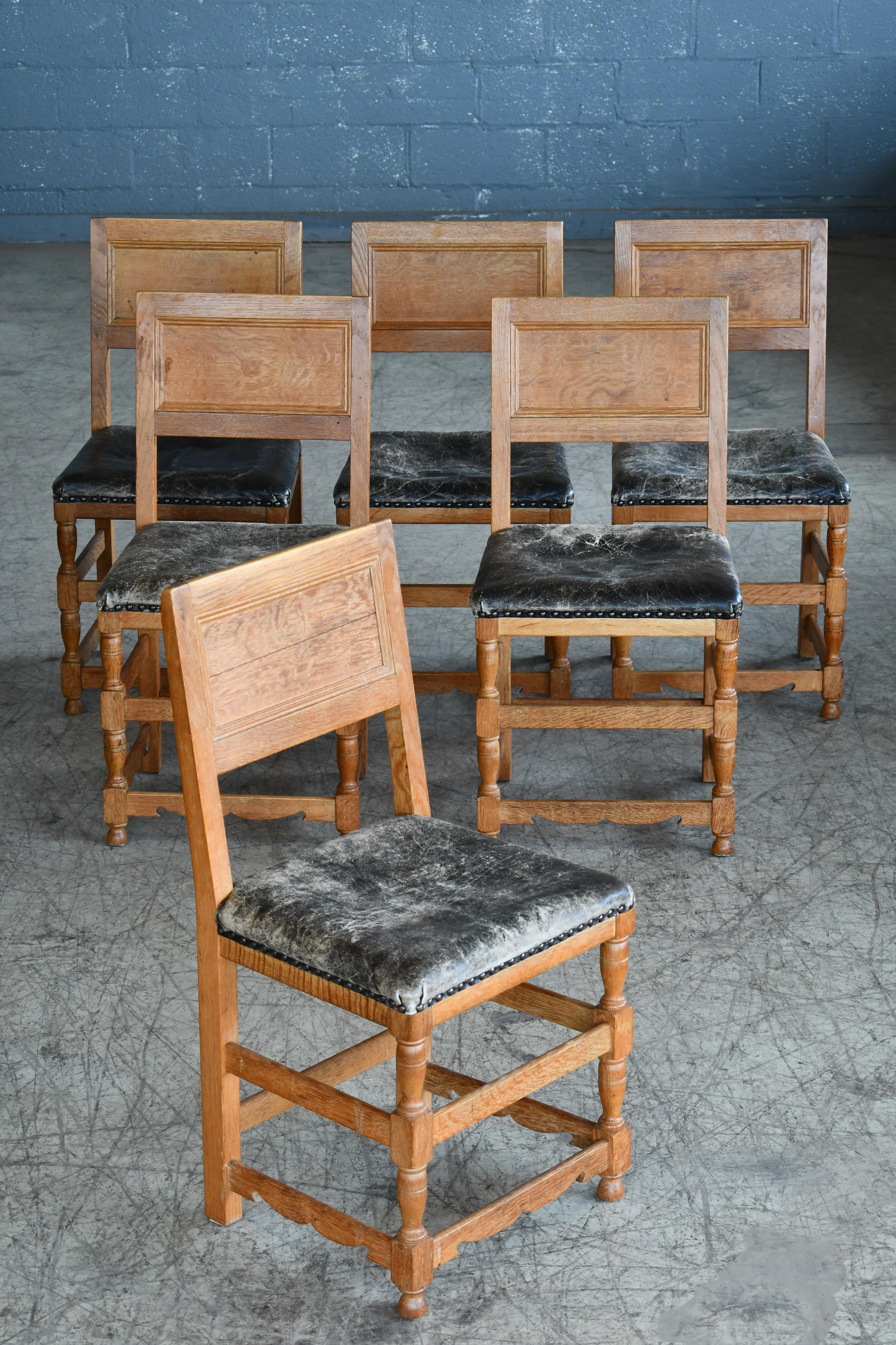 Great Danish dining chairs made round 1900. Rustic and very elegant in their simplicity, Made from oak and with leather seats that have obtained near perfect wear and patina over the years but are not ripped or torn. Sturdy and strong and overall