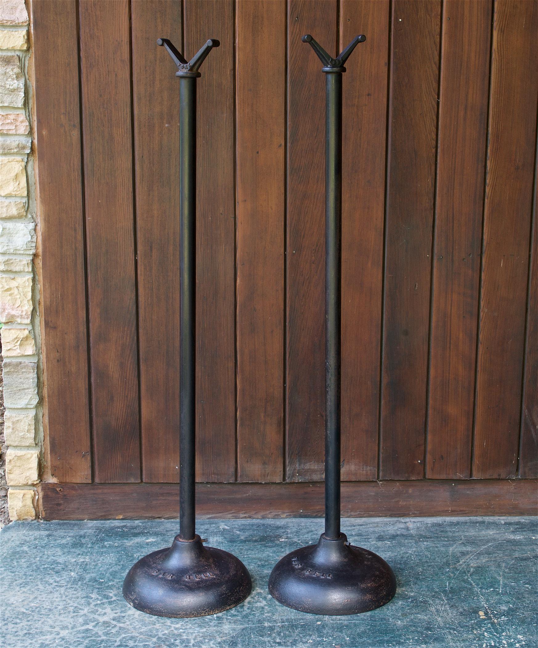 Early Century gym equipment, Cast Iron Bar Bell Stands Mfg. by York, USA, circa 1930s. Raised lettering in base, YORK BAR BELL. In good vintage condition, showing wear, oxidation and pitting to metal surfaces. 

Measures: Diameter 12 1/2 x height