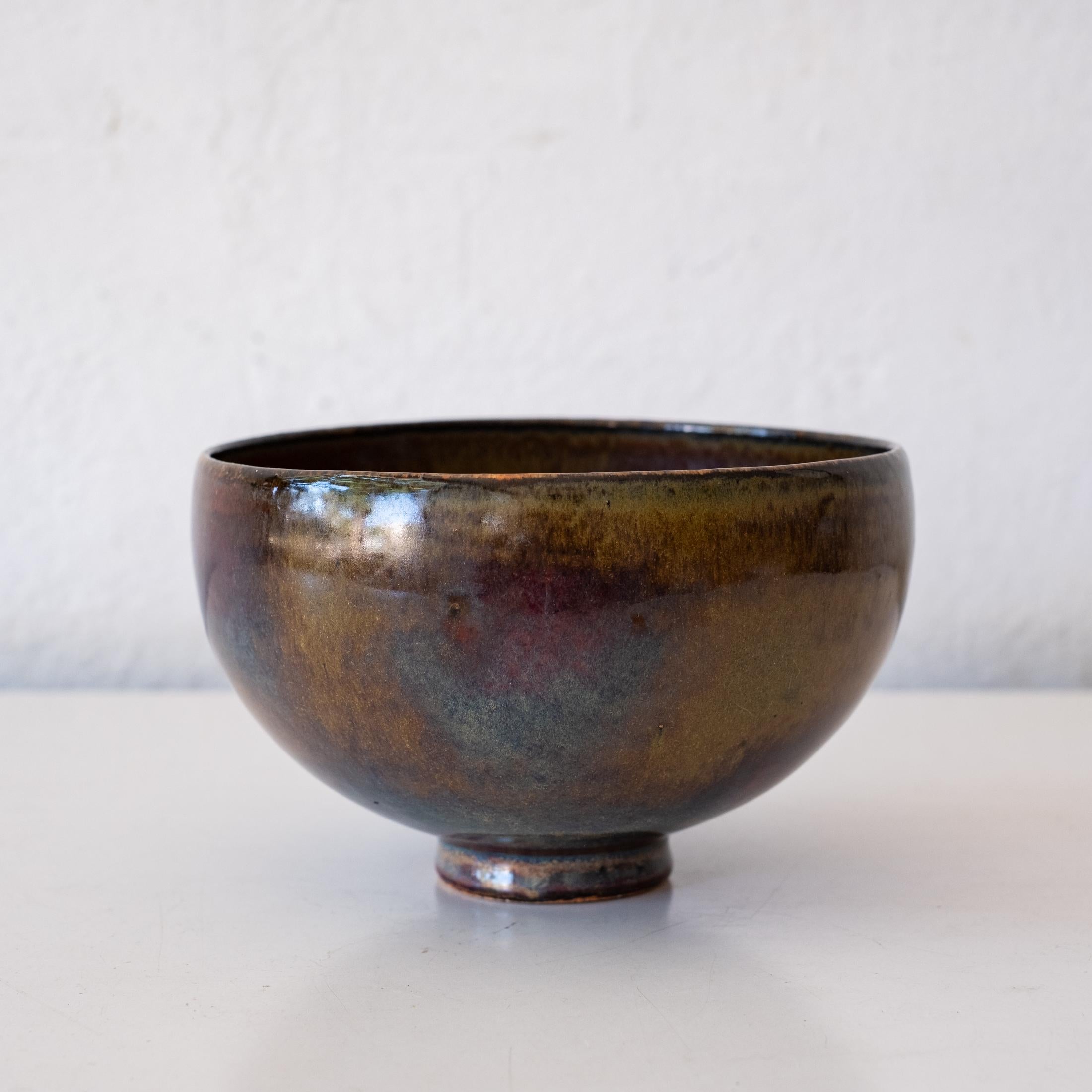 Beautiful early stoneware bowl by Edwin and Mary Scheier. Footed form in glossy copper, oxblood and blue. Signed in clay on bottom: Scheier

Edwin Scheier (1910–2008)
Mary Scheier (1908–2007)

Works by Scheier are included in major museum