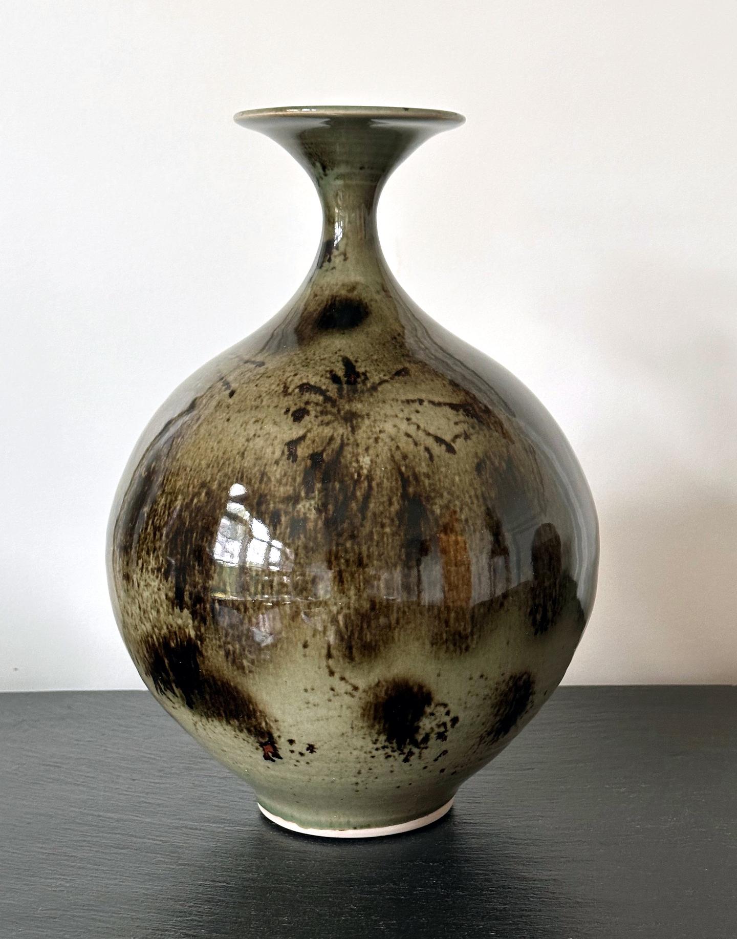 An early ceramic vase in a pear shape form by celebrated potter Brother Thomas Bezanson (1929-2007). The shape of this porcelain glazed vase is one of the Chinese prototypes known as Yuhuchun (Spring in the jade bottle). Originated in Tang Dynasty