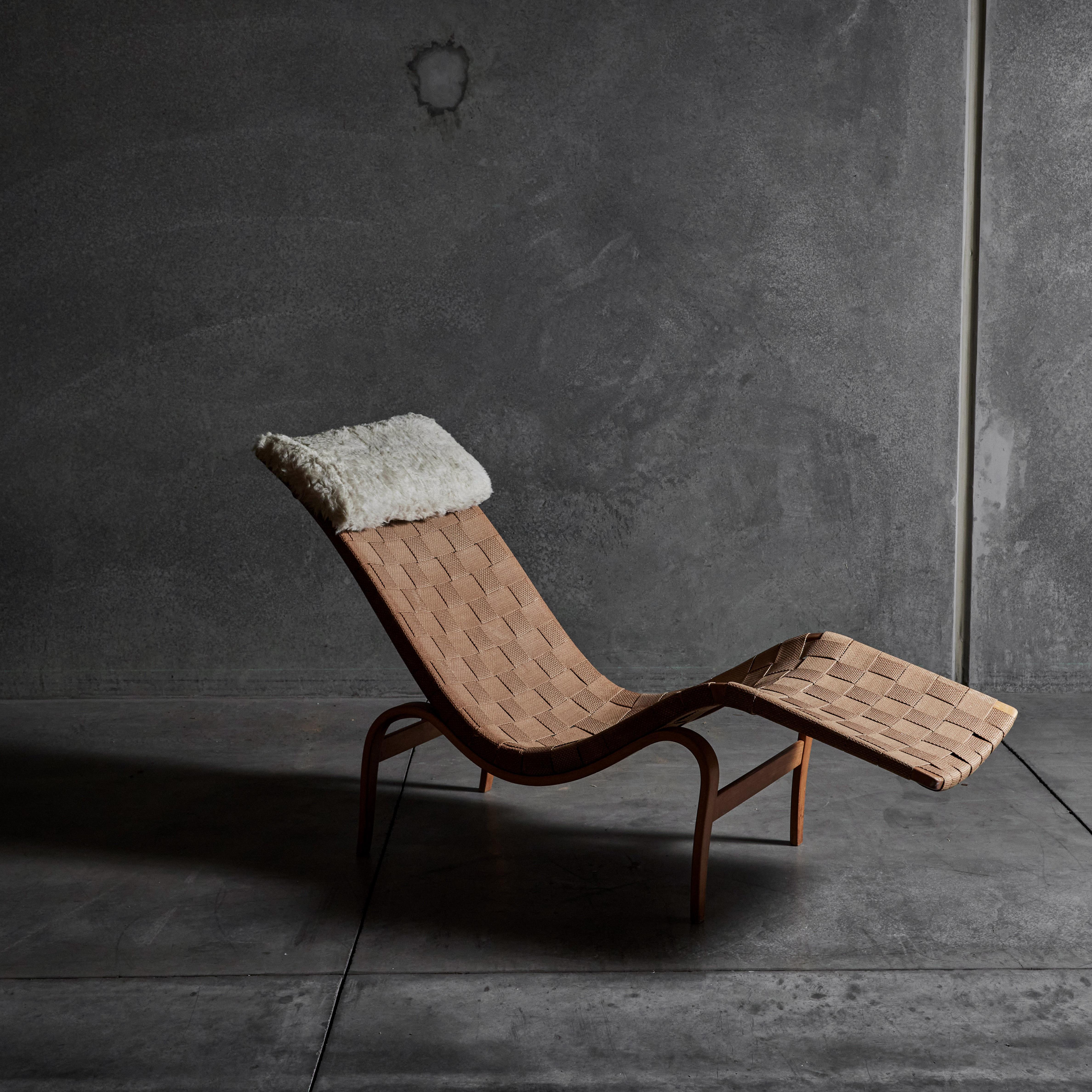 Early chaise lounge with original canvas webbing and detachable sheepskin pillow by Bruno Mathsson for Firma Karl Mathsson. Made in Sweden, circa 1936. Retains all original labels with dates.