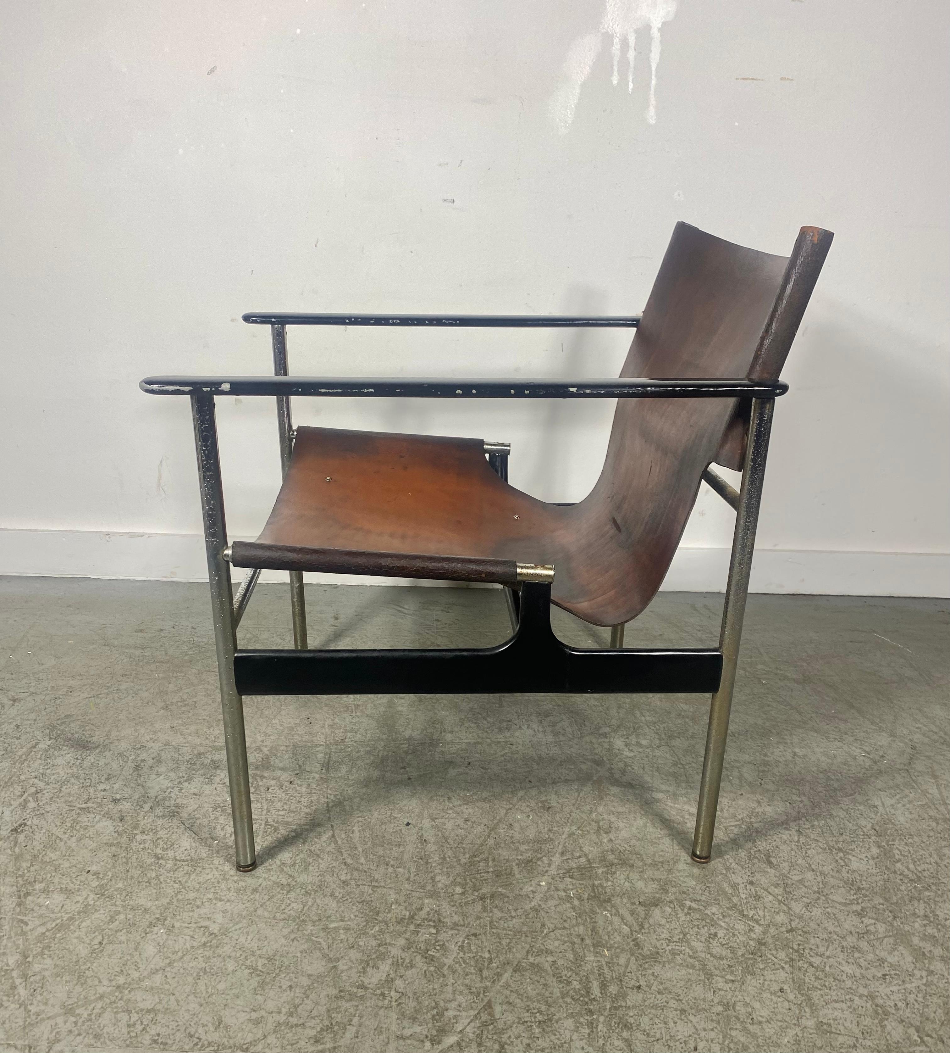A nice early example the Rare model 657 leather sling lounge chair by Charles  Pollock for Knoll, circa 1960. The leather has wonderful rick dark brown patina and is in good Vintage Condition. Chrome has some pitting and metal arms some paint loss..