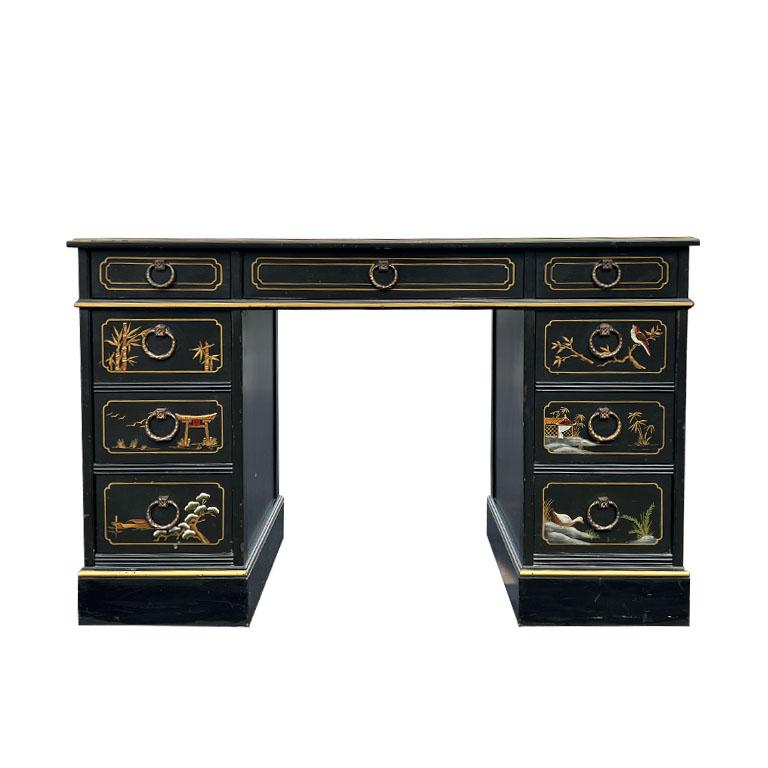 A beautiful japanned Nichols & Stone chinoiserie desk and matching chair set. The desk itself is swoon-worthy with its painted traditional scenes of a forest and stenciled gold details. The front of the desk features nine drawer fronts, each with