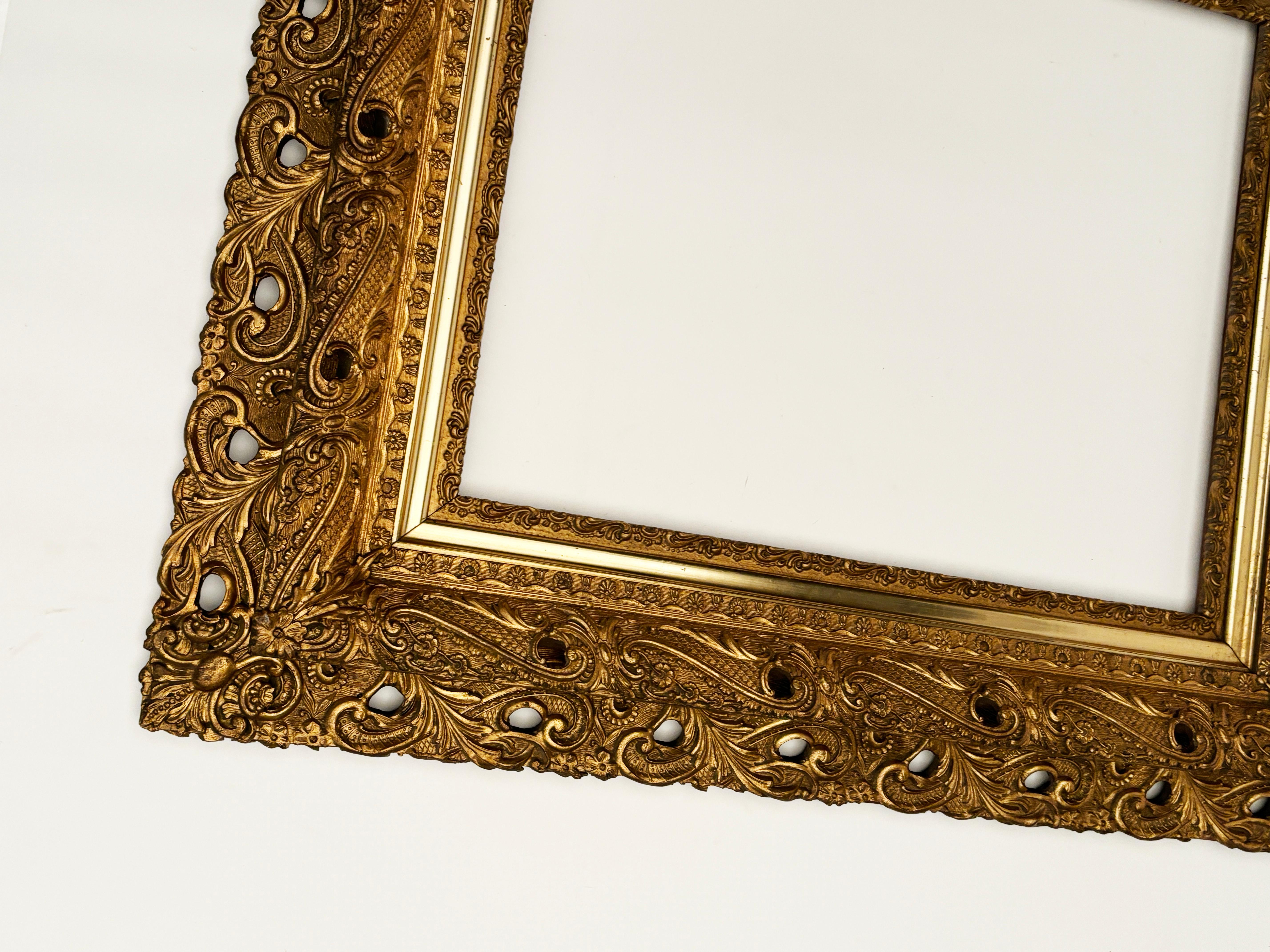 This intricate two-tier frame was created in the early to mid 19th century. Made from hand carved wood with intricate cut-outs,  this extraordinary frame was then built up into the most stunning designs using gilded plaster over top of the solid