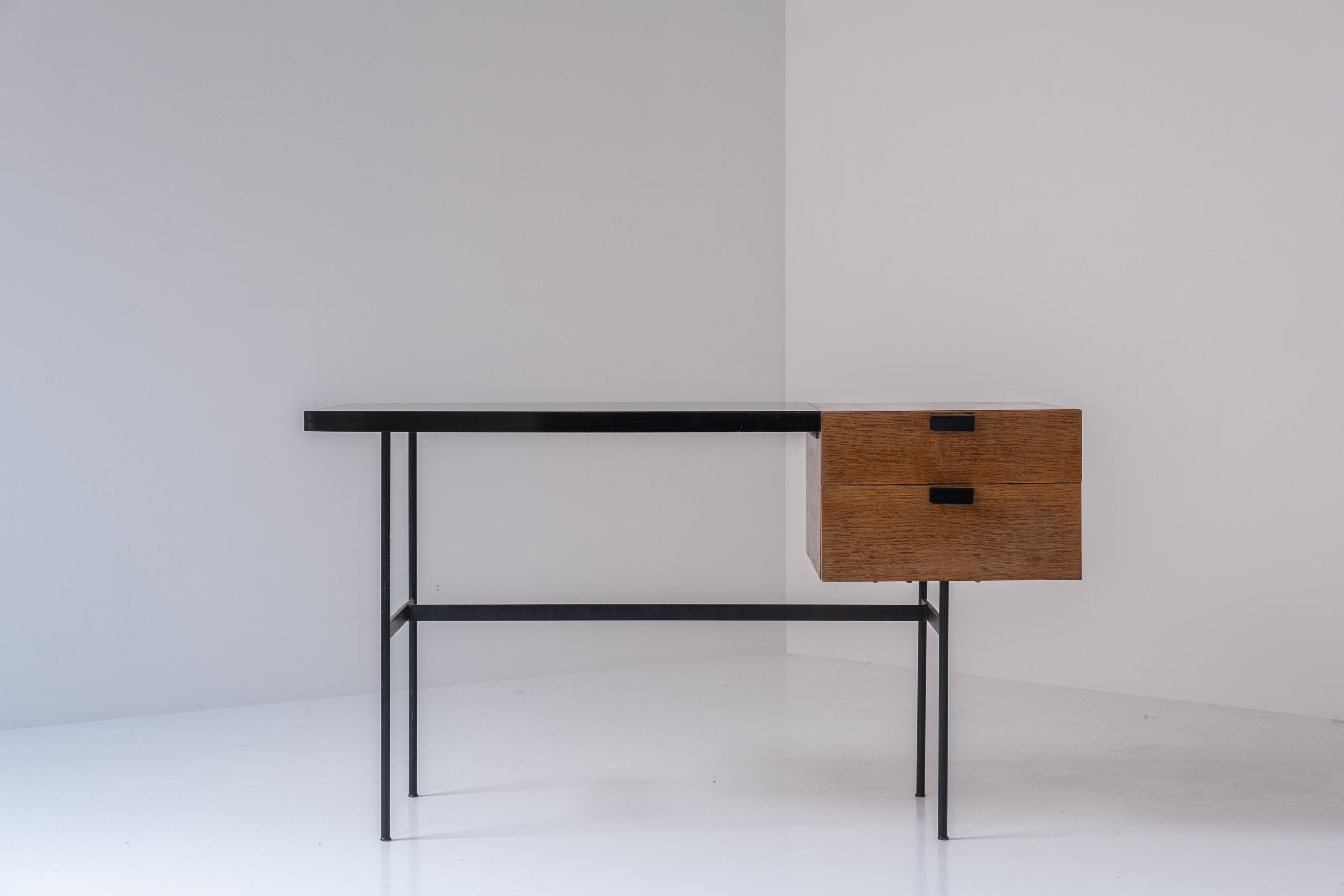 Admire this early ‘CM141’ desk by Pierre Paulin for Thonet, France 1953. This perfect proportioned desk features a black lacquered steel frame with a black formica top. On the right a drawer section made out of blond teak veneer. Restored with love.