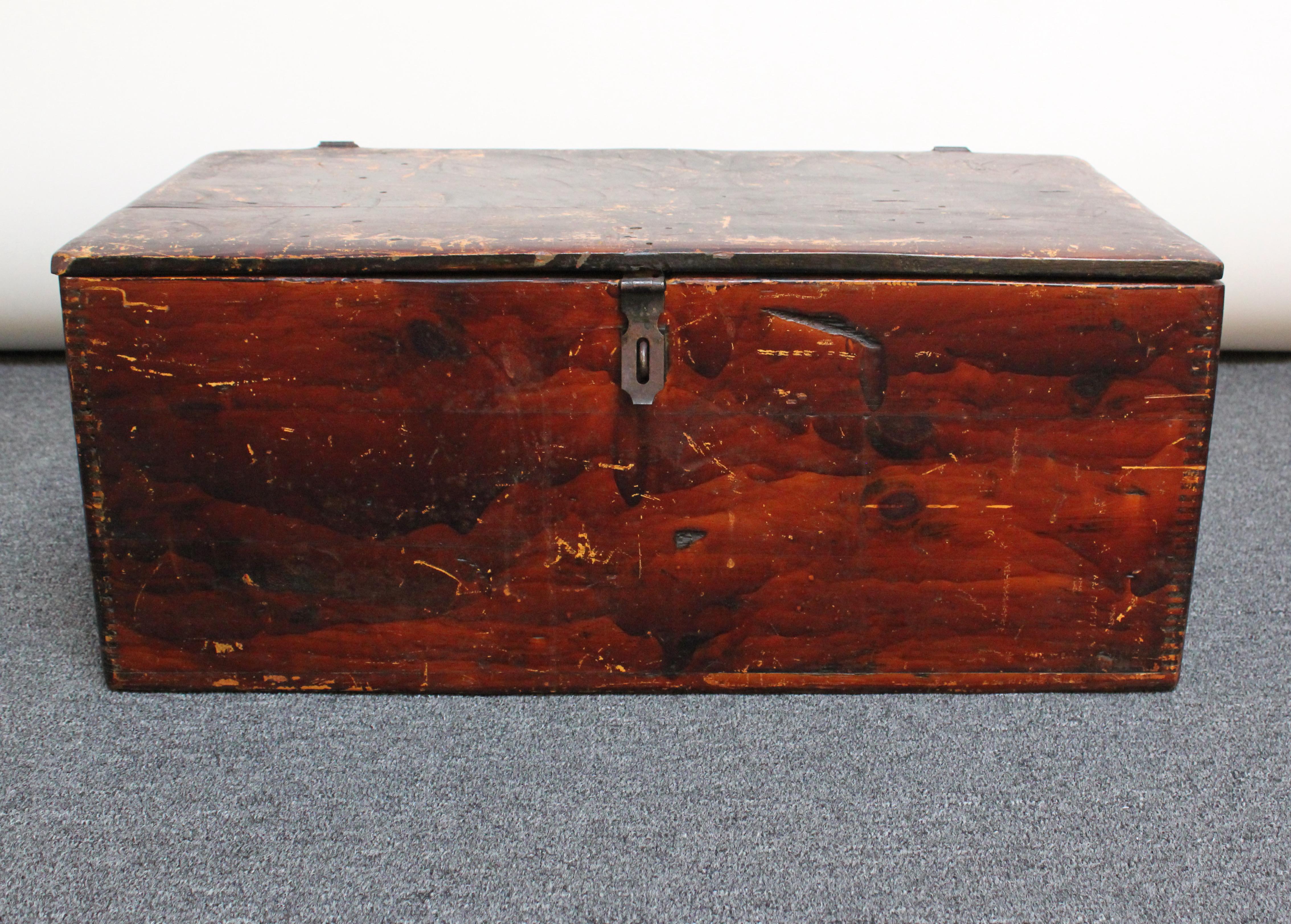 Handmade travel trunk carved from maple wood planks with applied steel hinges and clasp. 
The hinged top opens to reveal a removable, divided tray providing an additional storage compartment. 
The surface shows very early crude planing impressions,