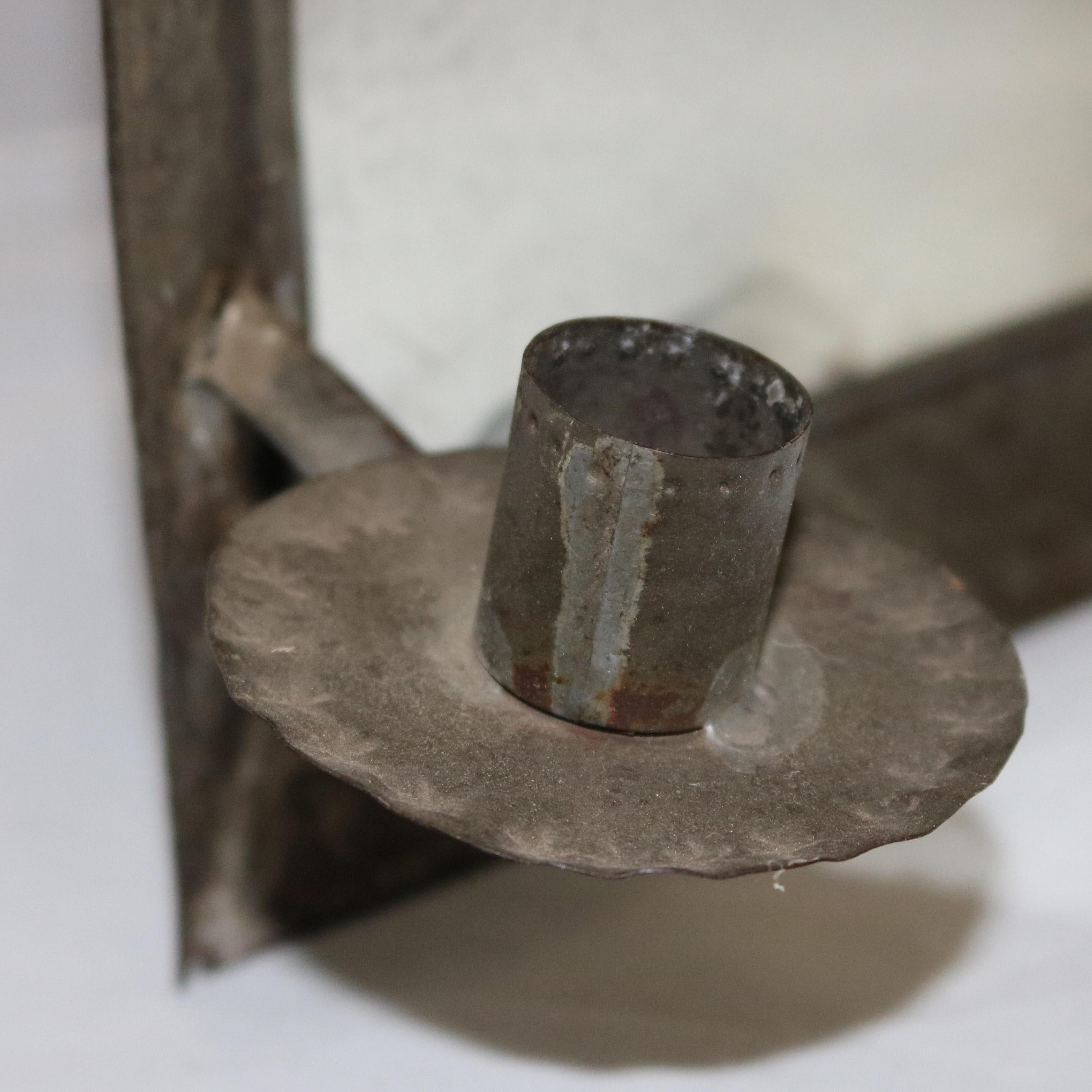 An early Colonial Williamsburg mirrored wall sconce offers pressed tin frame with diamond pattern and flanking candles, circa 1820

Measures: 12.5