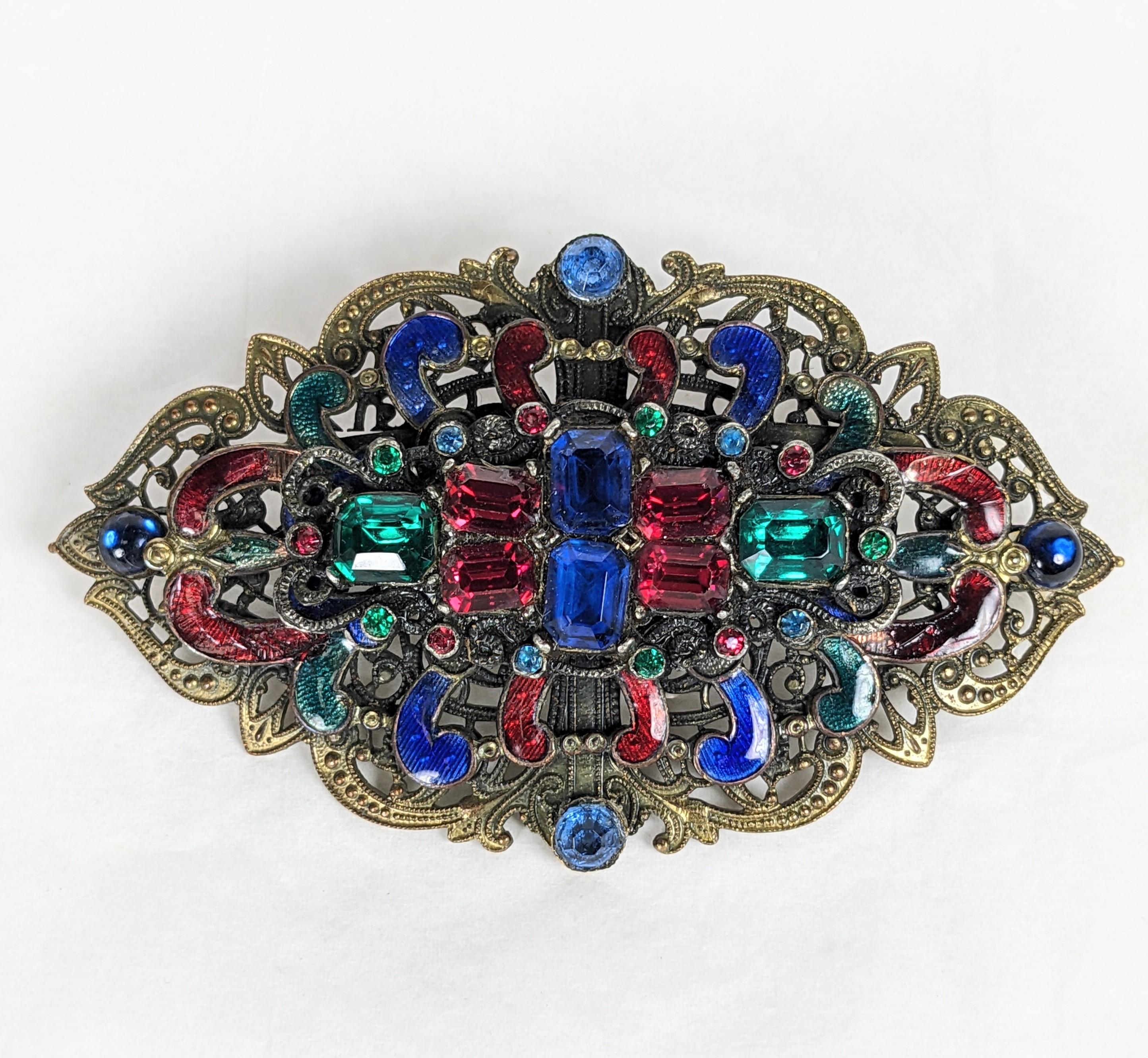 Early Czech Multi Paste Brooch from the 1920's. A filigree brass base is set with enamels and multicolored pastes of different sizes. Striking colorations. 3.5