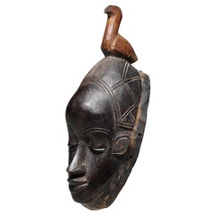 Early Danced Black Wood Mask From the Guro Peoples Ivory Coast Bird on top
