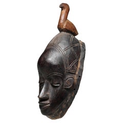 Masque en bois noir dansé The Guro Peoples Ivory Coast Bird on top