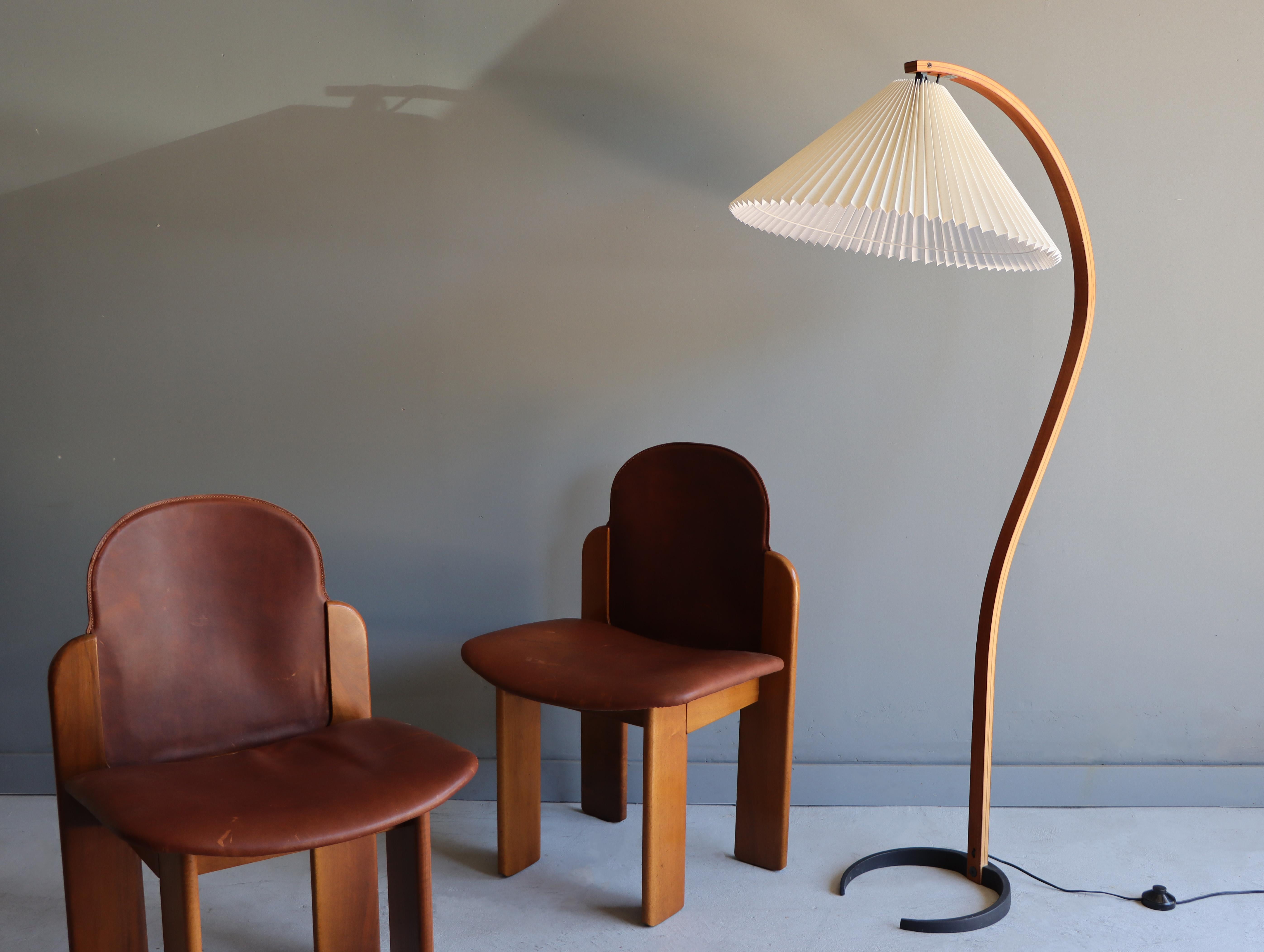 Early sculptural teak and beech floor lamp designed by Mads Caprani Denmark, circa 1970s. Iconic organic bentwood design complimented by its soft lighted pleated shade and crescent iron base. This design looks good from every angle. 

Features a