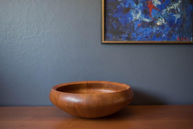 Mid century modern decorative staved salad serving bowl designed by Jens Harald Quistgaard for Dansk, Denmark. This unique piece displays quality solid teak craftsmanship and makes for a stunning centerpiece for any occasion. Branded with the early