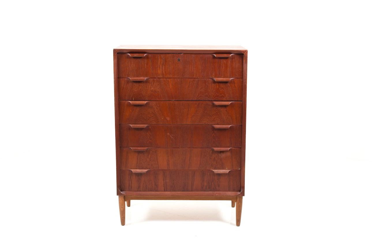 Midcentury Danish chest of drawer in teak. Font with 3 drawers. Standing on conical round feet made of solid oak. Early production.
