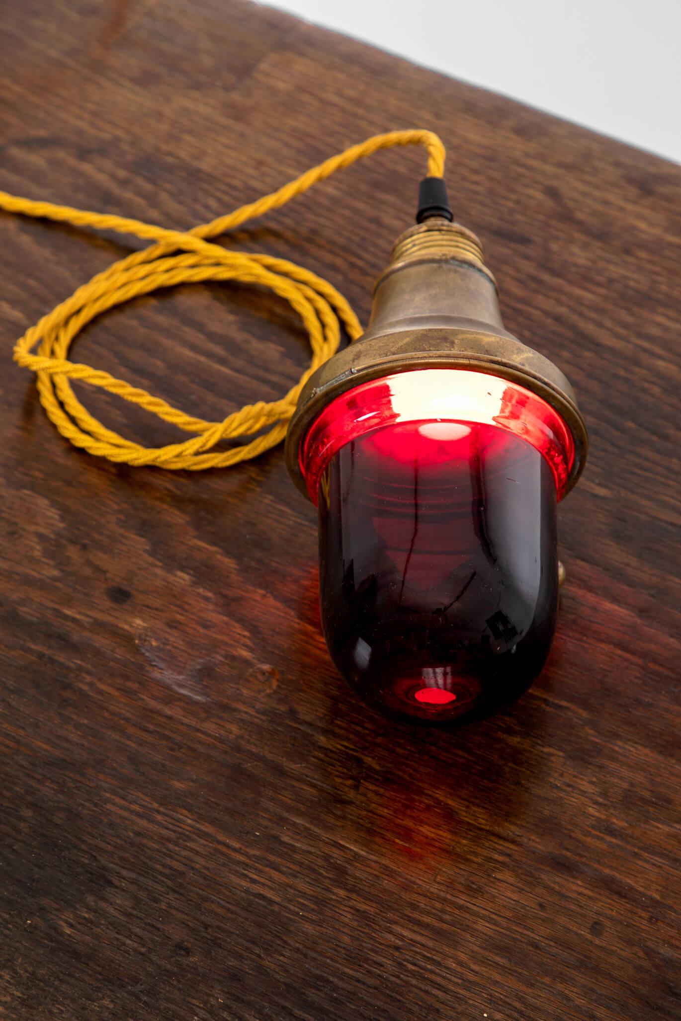 A superb darkroom lamp from a photographic studio. 
The lamp is also referred to as a ‘safelight’ as it provides illumination in the development of light-sensitive photographic images. Often dark red lighting is used in such studios as it emits low