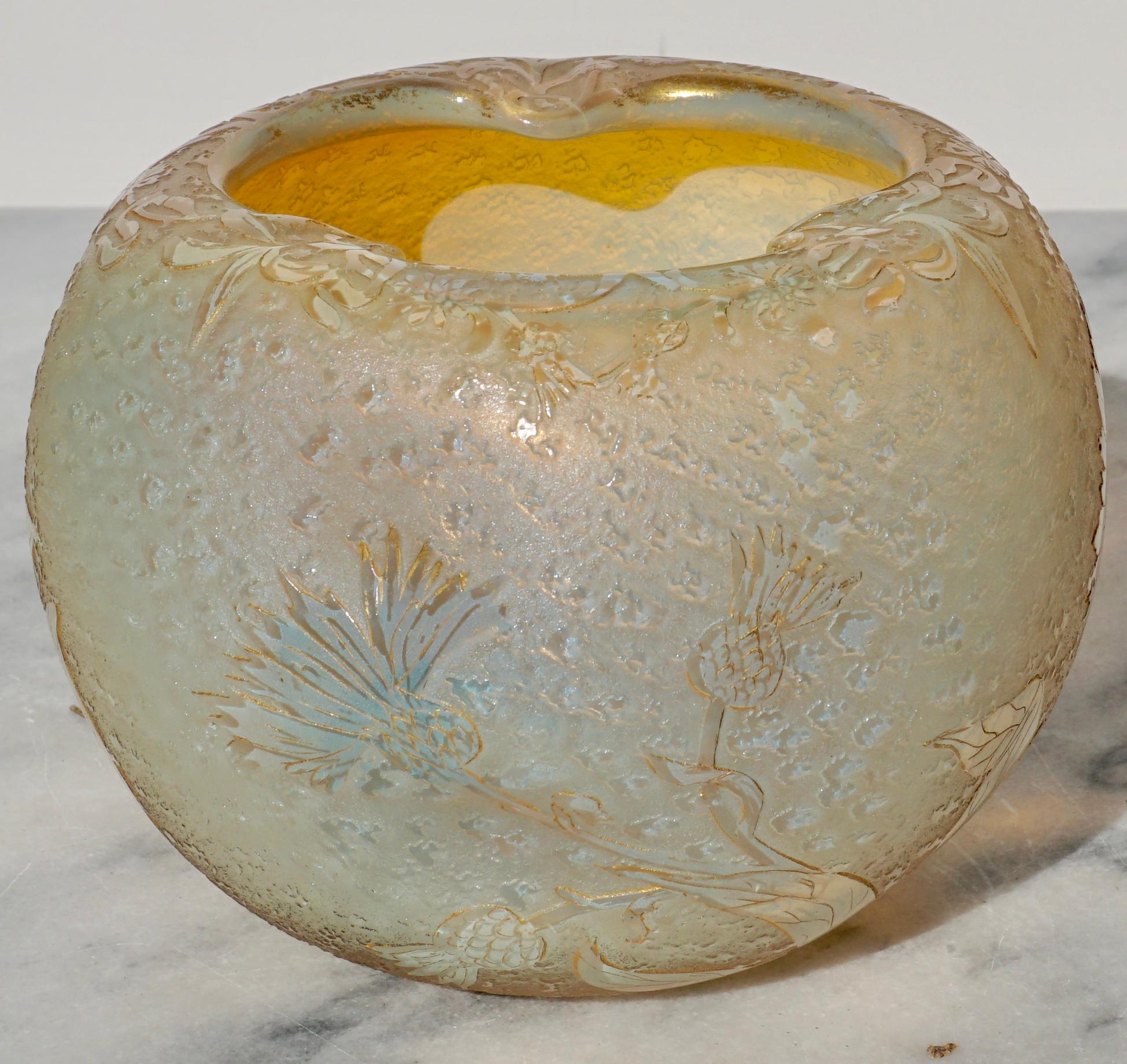 This Iridescent and opalescent acid etched and carved glass vase by Daum Nancy makes for a perfect bouquet of flowers. Dimpled or pinched three times at top opening shows remains of gold gilding as the whole vase does throughout. 

Signed in