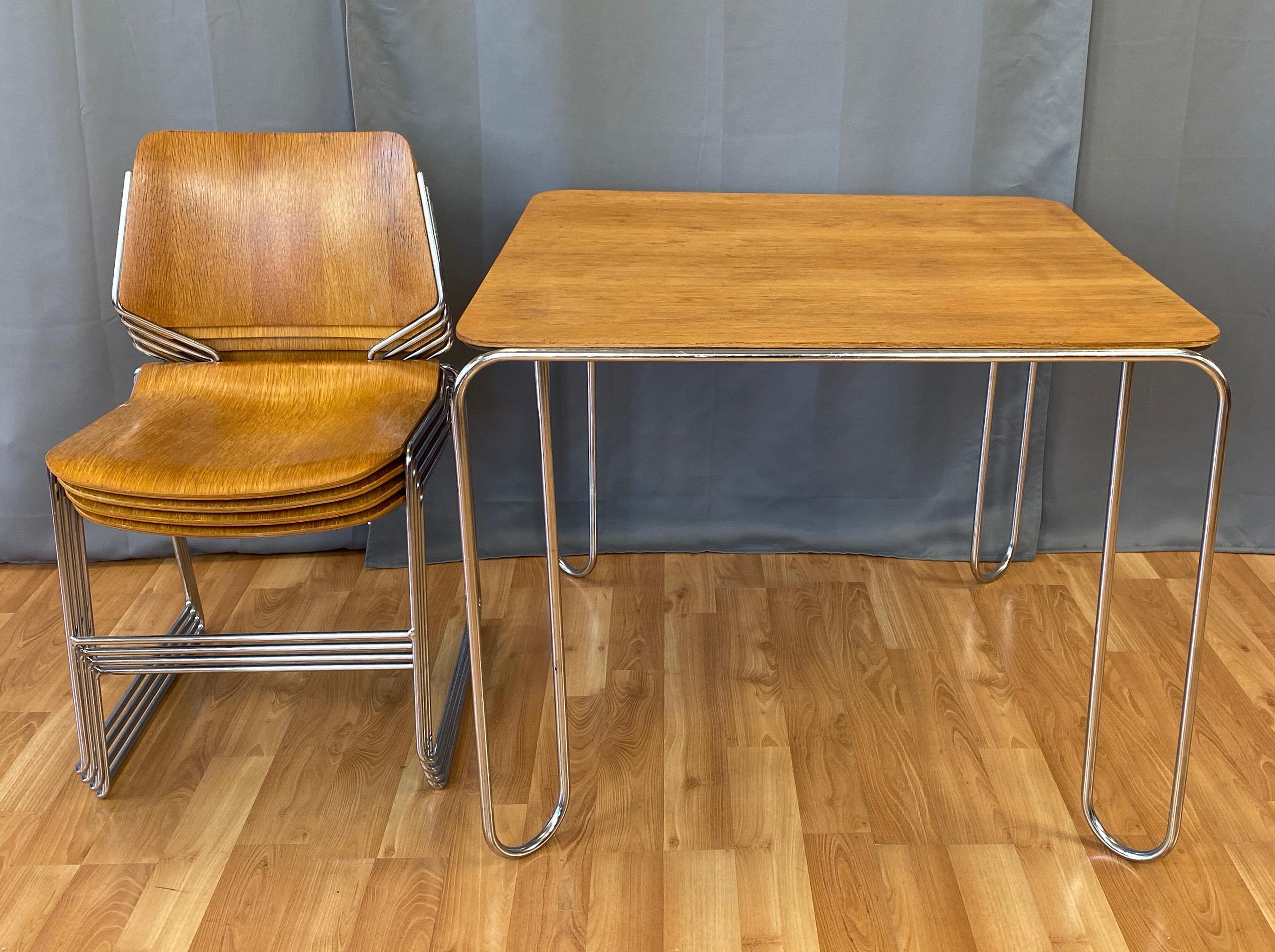 A five-piece set of four oak 40/4 stacking chairs and matching table by David Rowland, likely from the late 1960s or early 1970s.

Chair with oak veneer over bentwood seat and back on chrome finish steel rod frame. Has a spare yet elegant aesthetic,