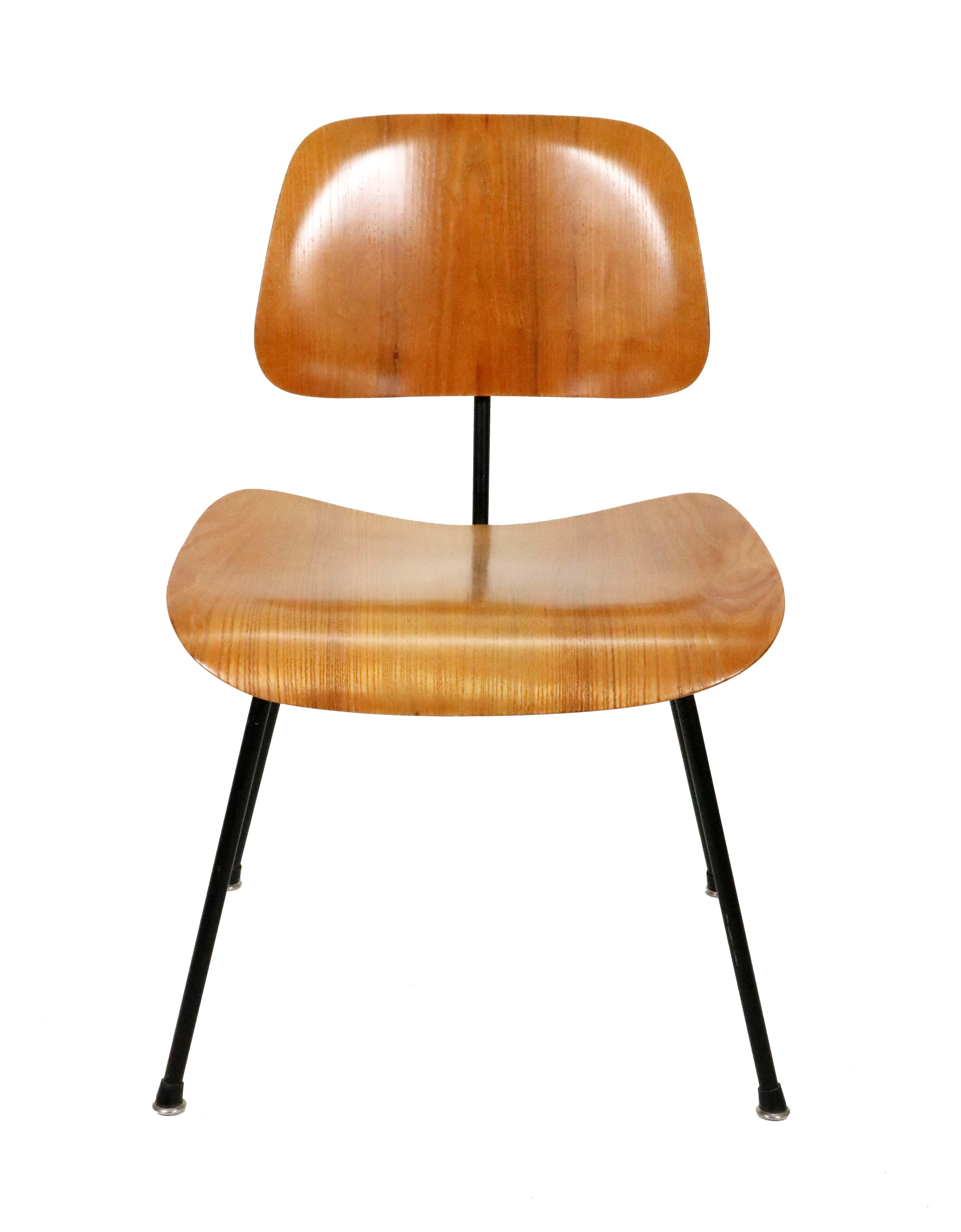 A recently refinished DCM chair by Charles and Ray Eames for Herman Miller with a steel black powder-coated base, walnut shells and new boot glides. 

Patent numbers document its manufacture to 1956-1959.