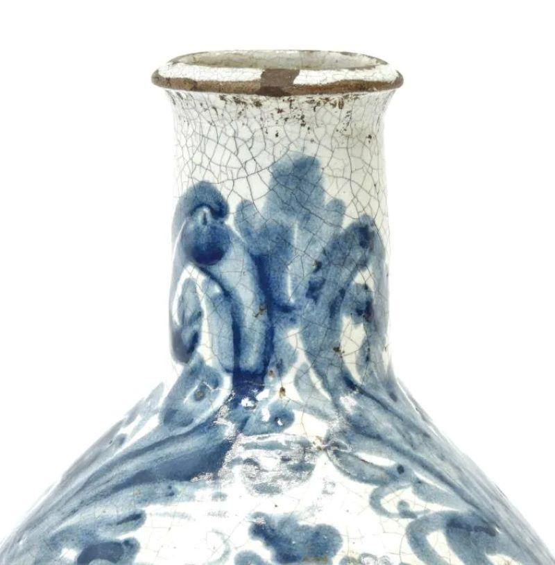 An early delft bottle with blue decoration depicting a castle with floral designs, circa 1690, Netherlands.