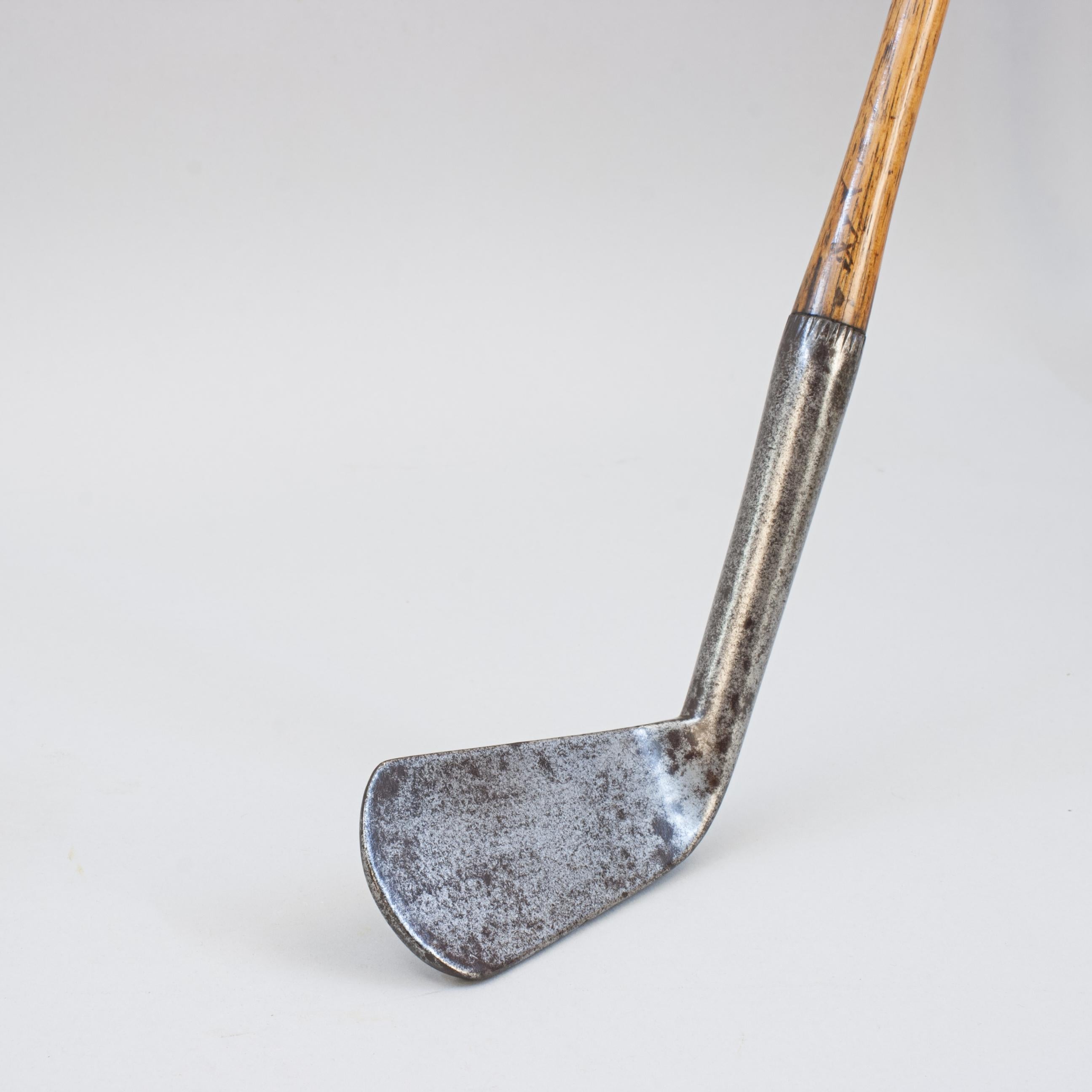Antique John Gray Hickory Golf Club, Prestwick.
This early large head hickory shafted lofting iron with a concave smooth face is a fine example of John Gray's work. The back of the iron club head has an excellent deep name stamp ' Jn. Gray' and good