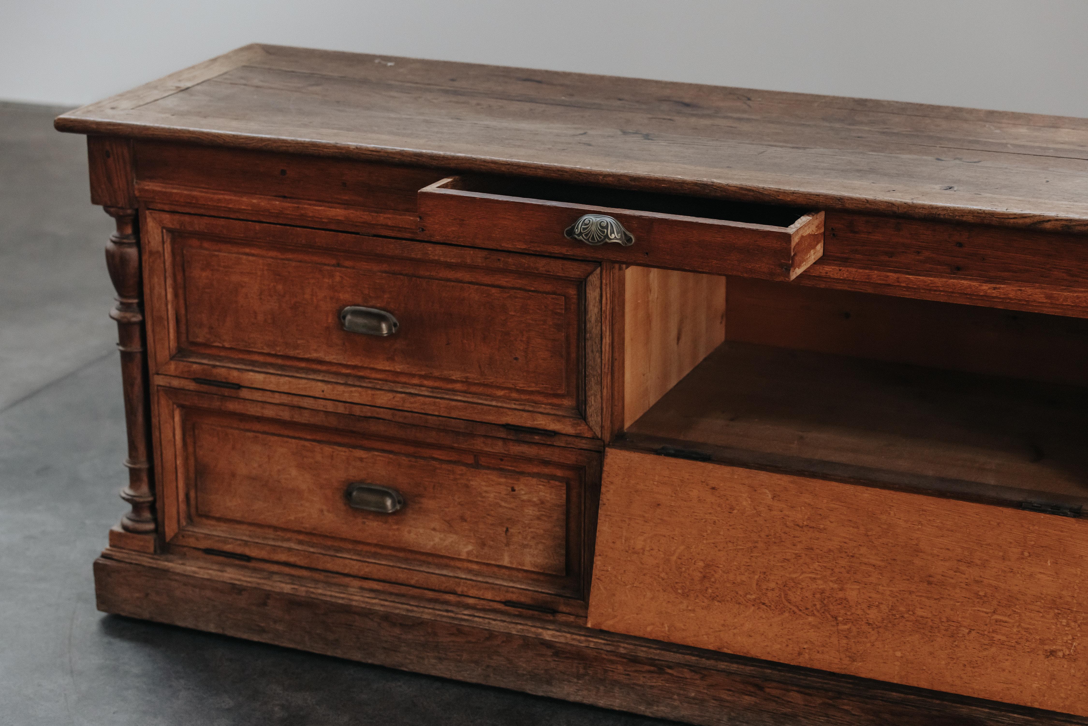 Early Double Sided Shop Counter From France, Circa 1900.  Solid oak construction with four doors and original hardware.  Great original patina and use.