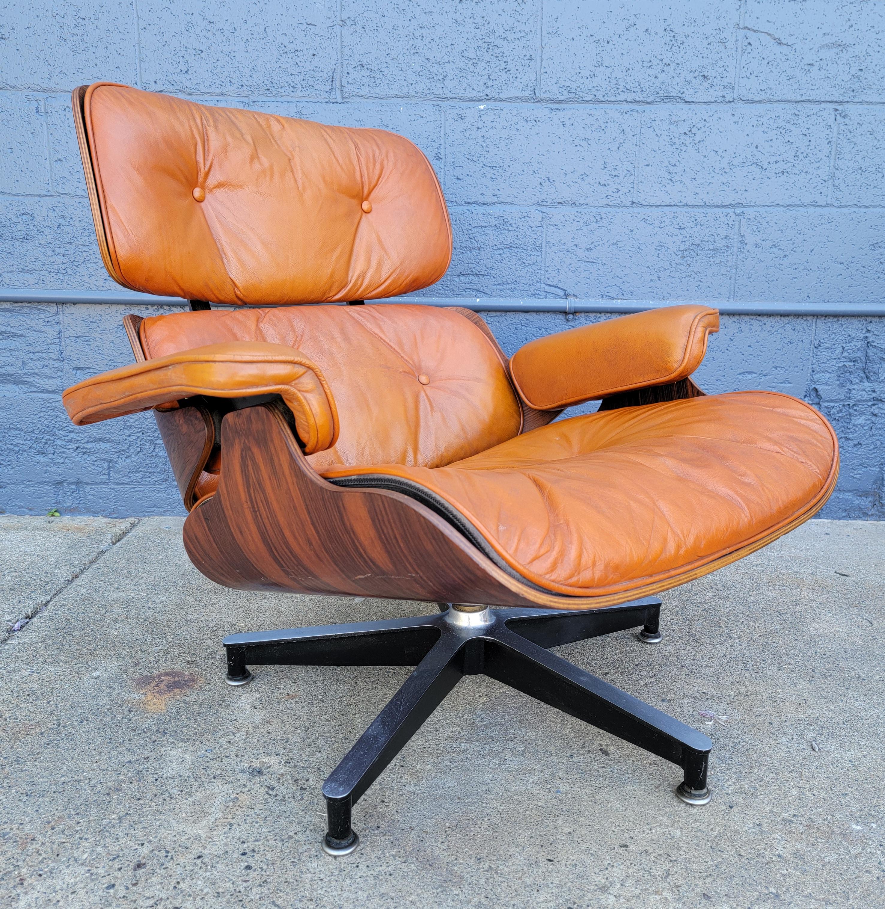 Charles & Ray Eames / Herman Miller 670 lounge chair in Rosewood with original caramel leather. Circa. 1960's. Exceptional figured wood grain with book-matched back panels. Down & foam filled cushions, original glides. Very good original vintage