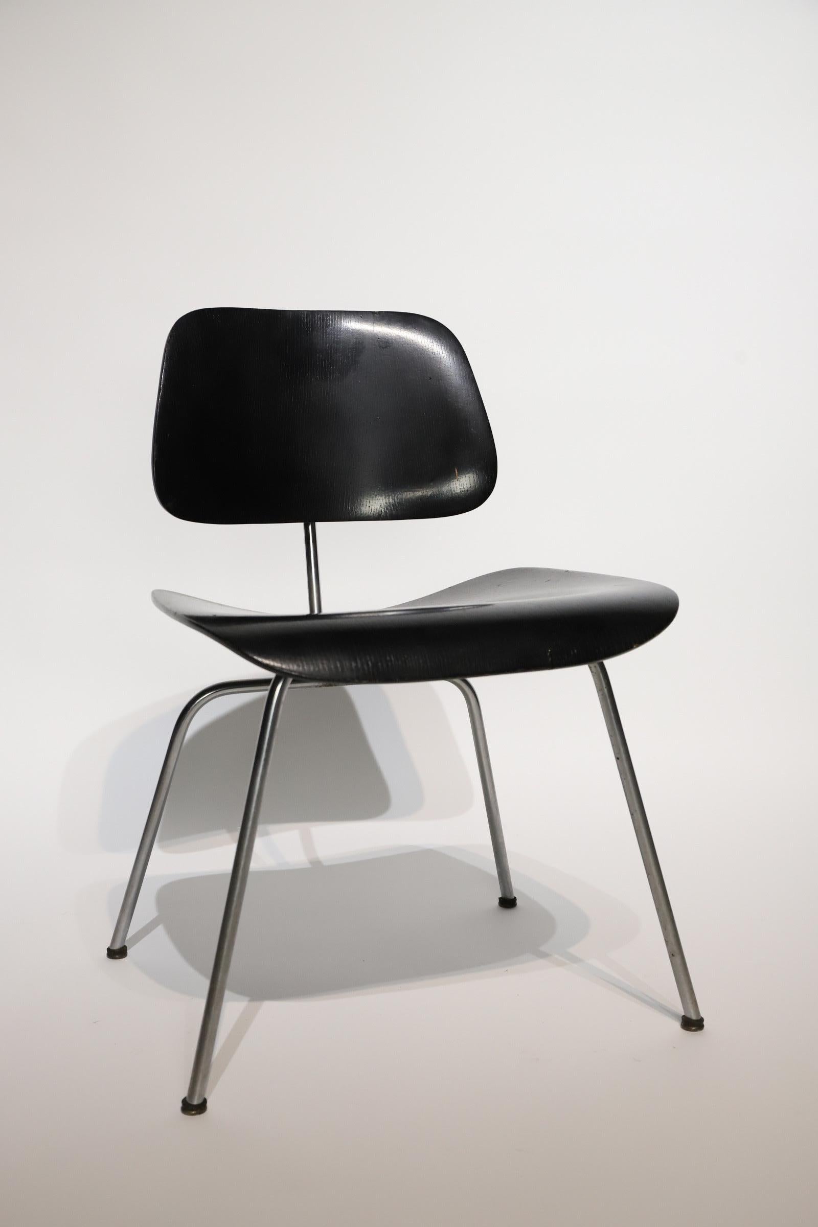 Early aniline dyed black Eames DCM for Herman Miller. Photographed with Cappellini side table and Noguchi lamp for scale. 