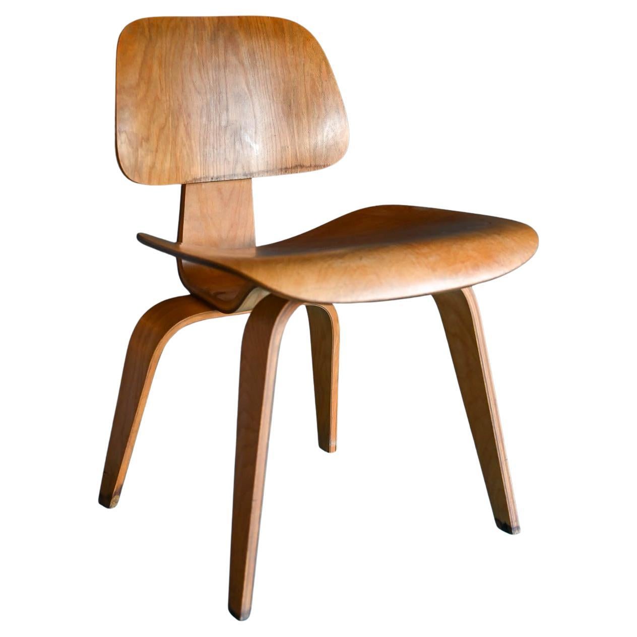 Early Eames DCW in Ash, ca. 1955.  Iconic and classic Charles Eames for Herman Miller DCW (dining chair wood) in Ash.  Marked with impressed DCW on underside.  This chair is in good overall condition.
