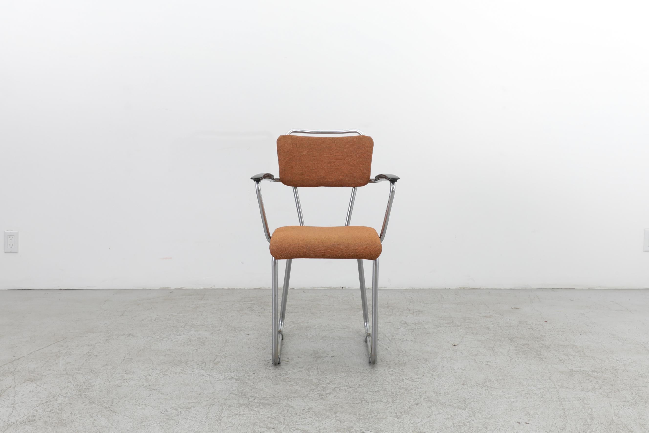 Early edition Gispen 214 desk chair with armrests designed by Christoffel Hoffmann for Gispen in 1950. With a tubular steel frame, original burnt orange upholstery and bakelite arm rests. In original condition with fading to the upholstery as well