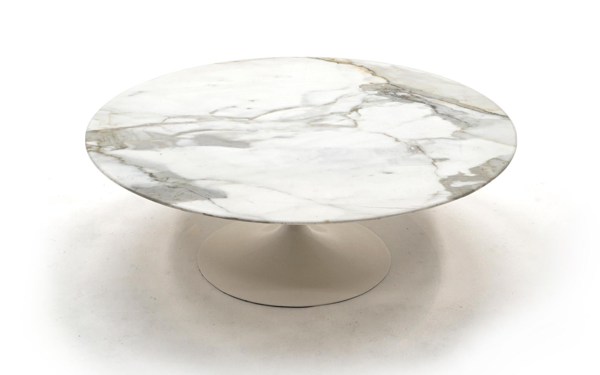 Early tulip base round Carrara marble coffee table by Eero Saarinen. Early and rare cast iron base which is quite heavy. Original top that we have had professionally polished leaving no scratches, no water rings. Excellent. Measures: 42 inch top.