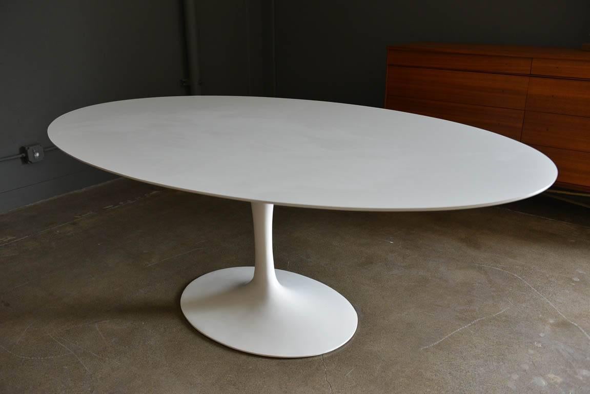 Early production Eero Saarinen for Knoll oval tulip dining table, circa 1955. Excellent vintage condition with only slight wear to base. Very early production base is solid cast iron rather than hollowed iron or cast aluminium, as in later