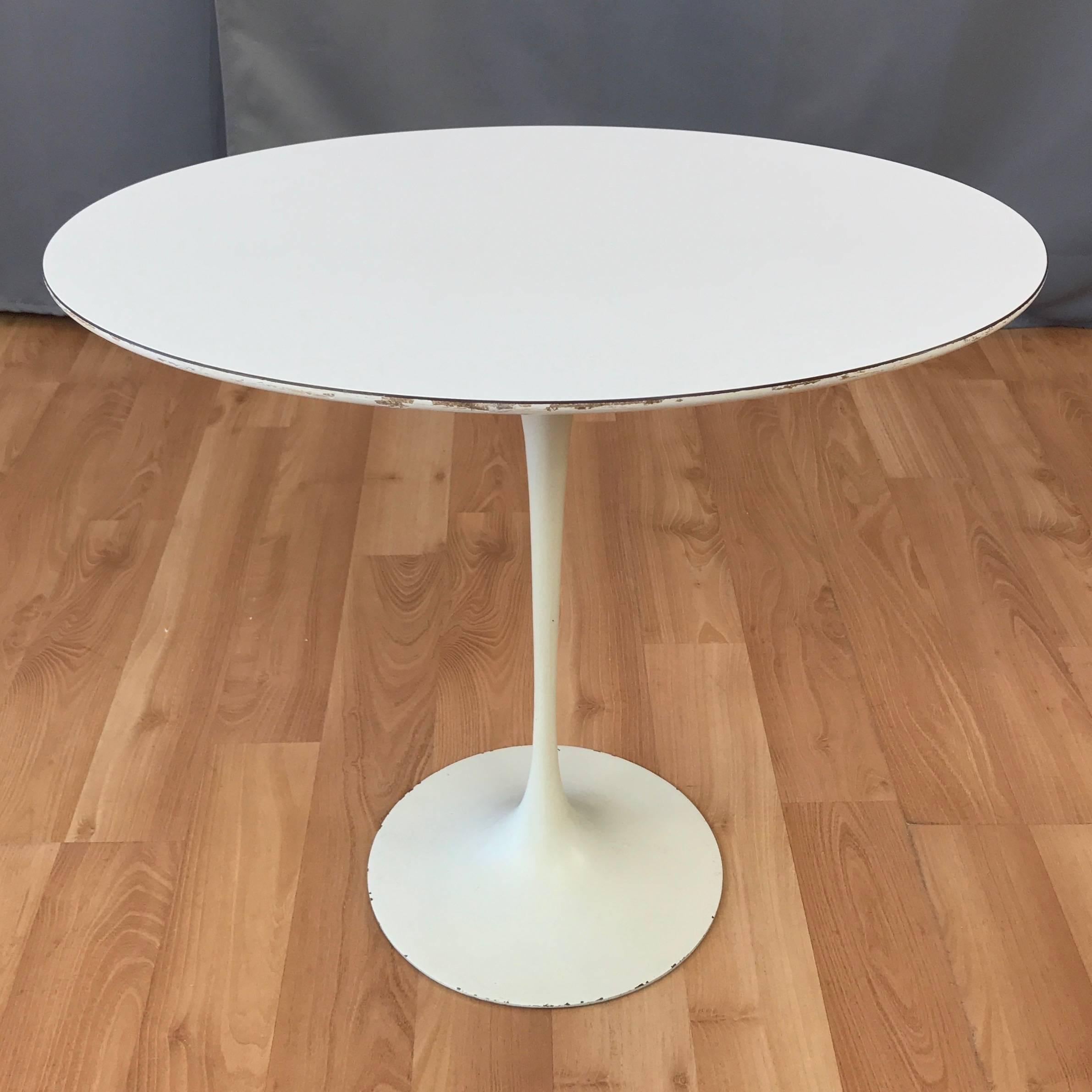 An early Pedestal Collection oval side table with laminate top by Eero Saarinen for Knoll. 

Designed in 1957 and more commonly referred to as the Tulip table, this example of the Mid-Century Modern furniture icon dates from the late 1950s. Features
