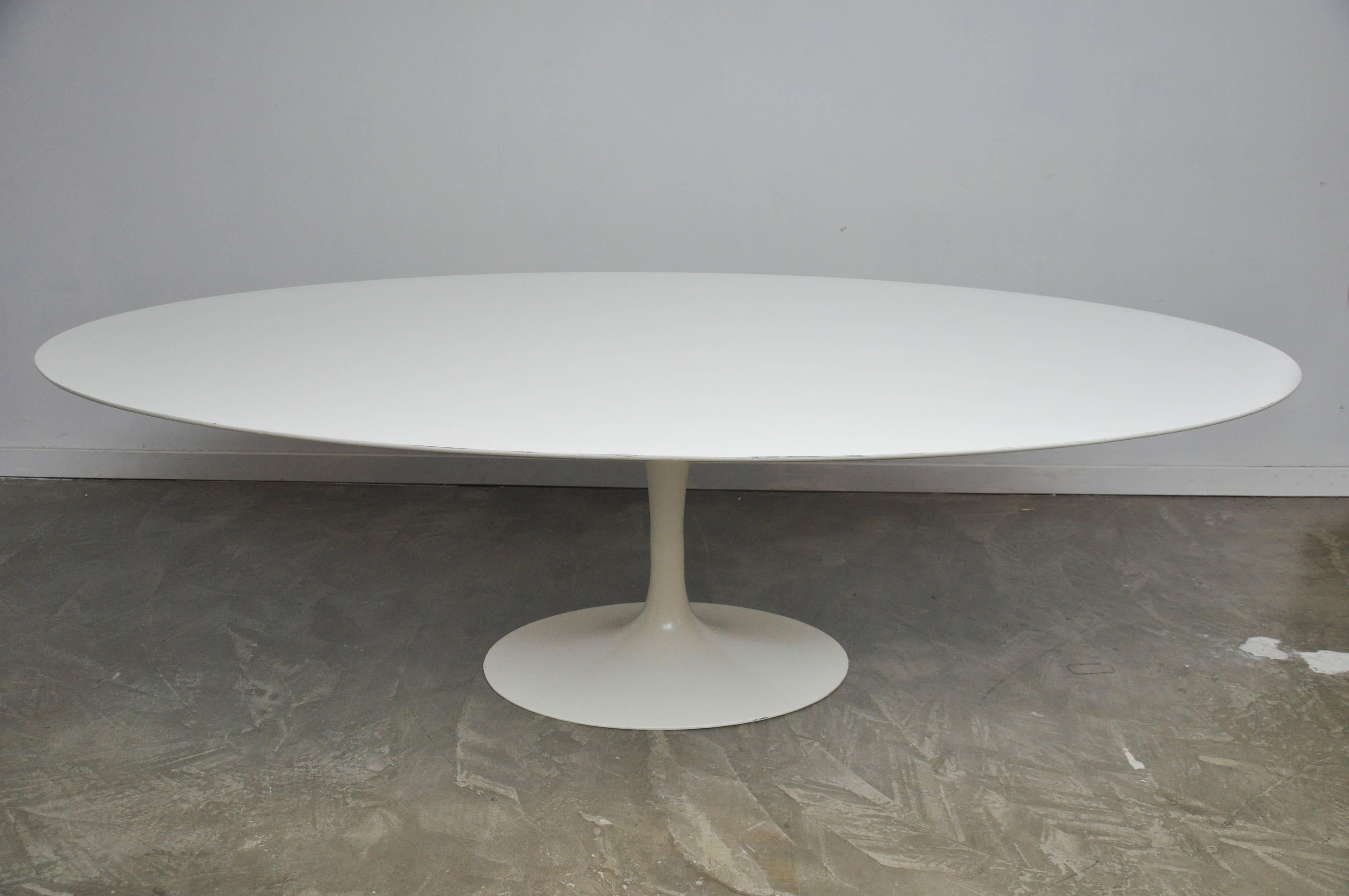 Early oval tulip dining table with cast iron base by Eero Saarinen for Knoll. This is the large 97