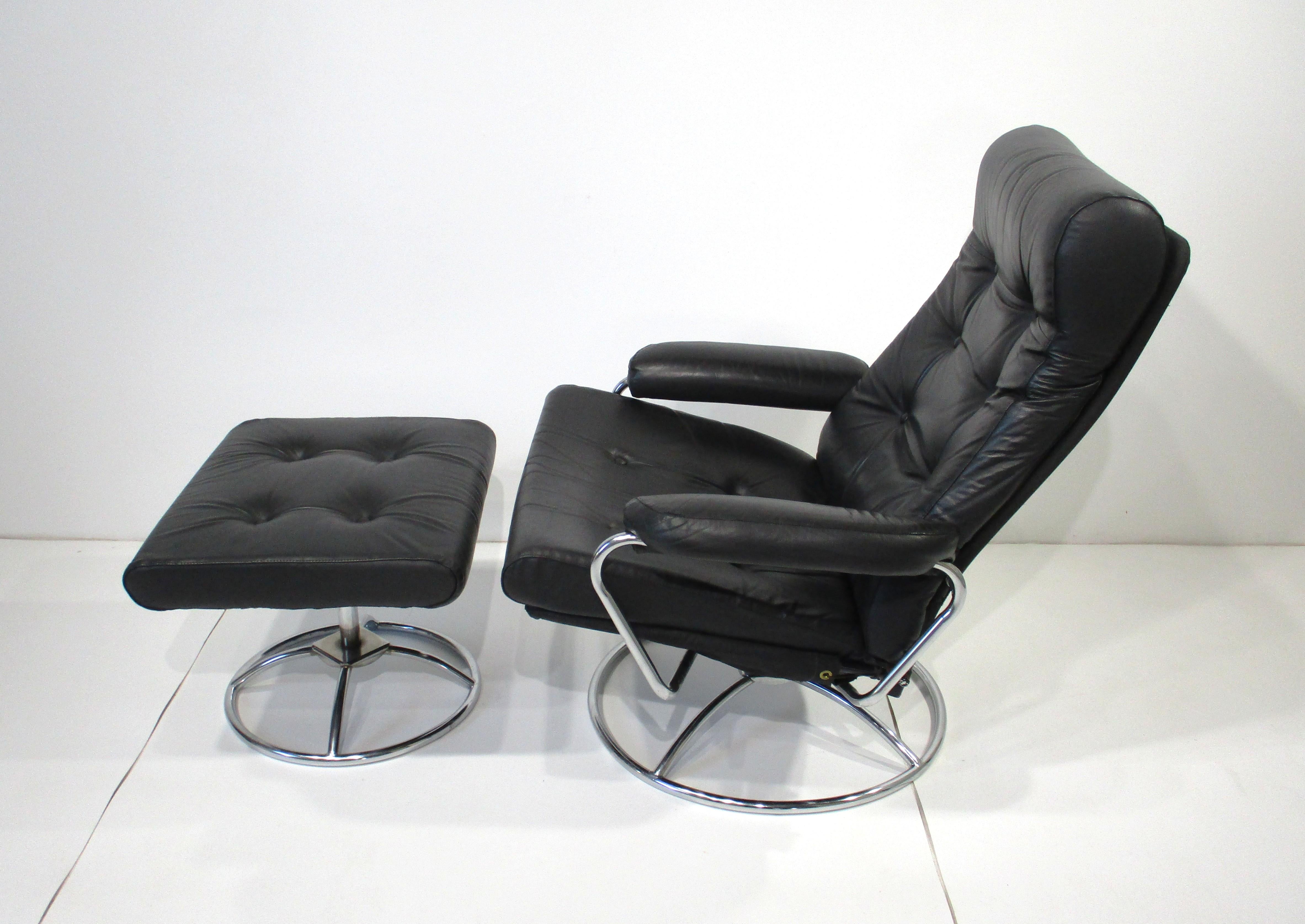 A very early Ekornes black leather lounge chair and ottoman with swiveling chrome base and buttons to the cushions . This chair is adjustable giving you plenty of comfort with it's simple design and functional ergonomics which is typical of