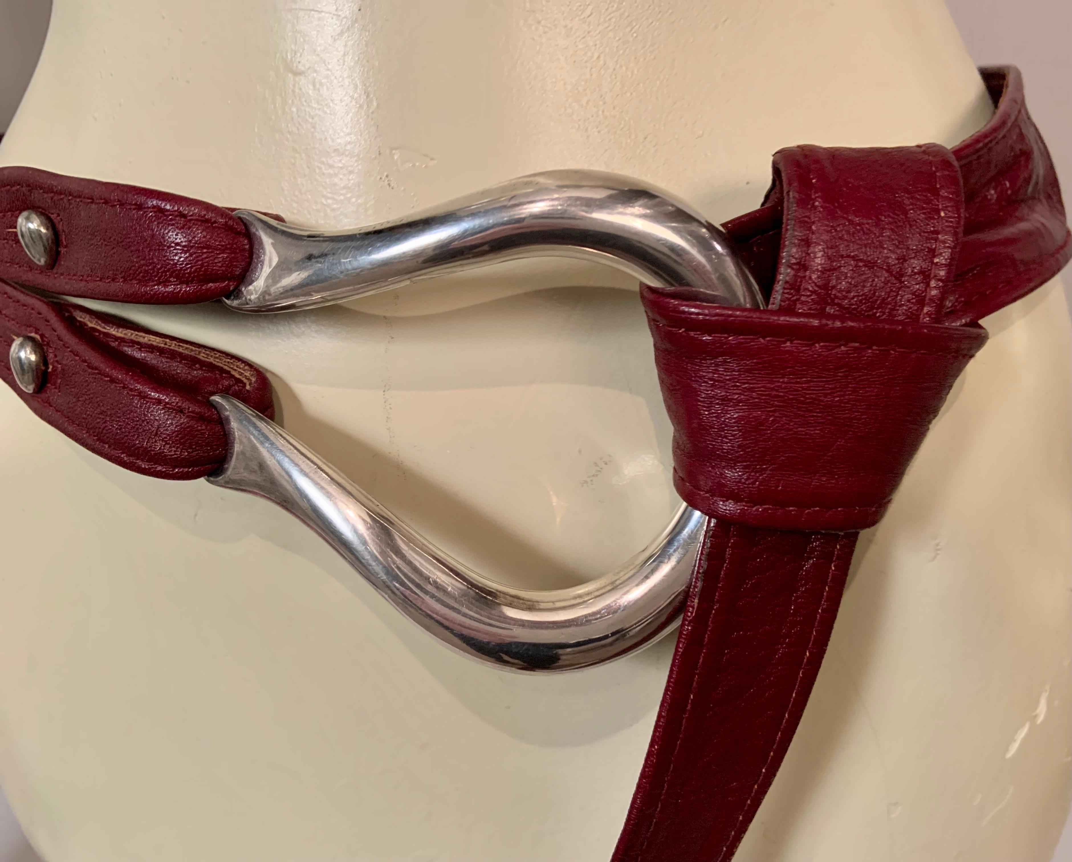 This is a very early belt designed by Elsa Peretti for Halston and retailed by Tiffany & Co. The sterling silver equestrian buckle is attached to a brown leather belt by two sterling buttons. These have the early mark, P for Peretti, T & Co and 925.