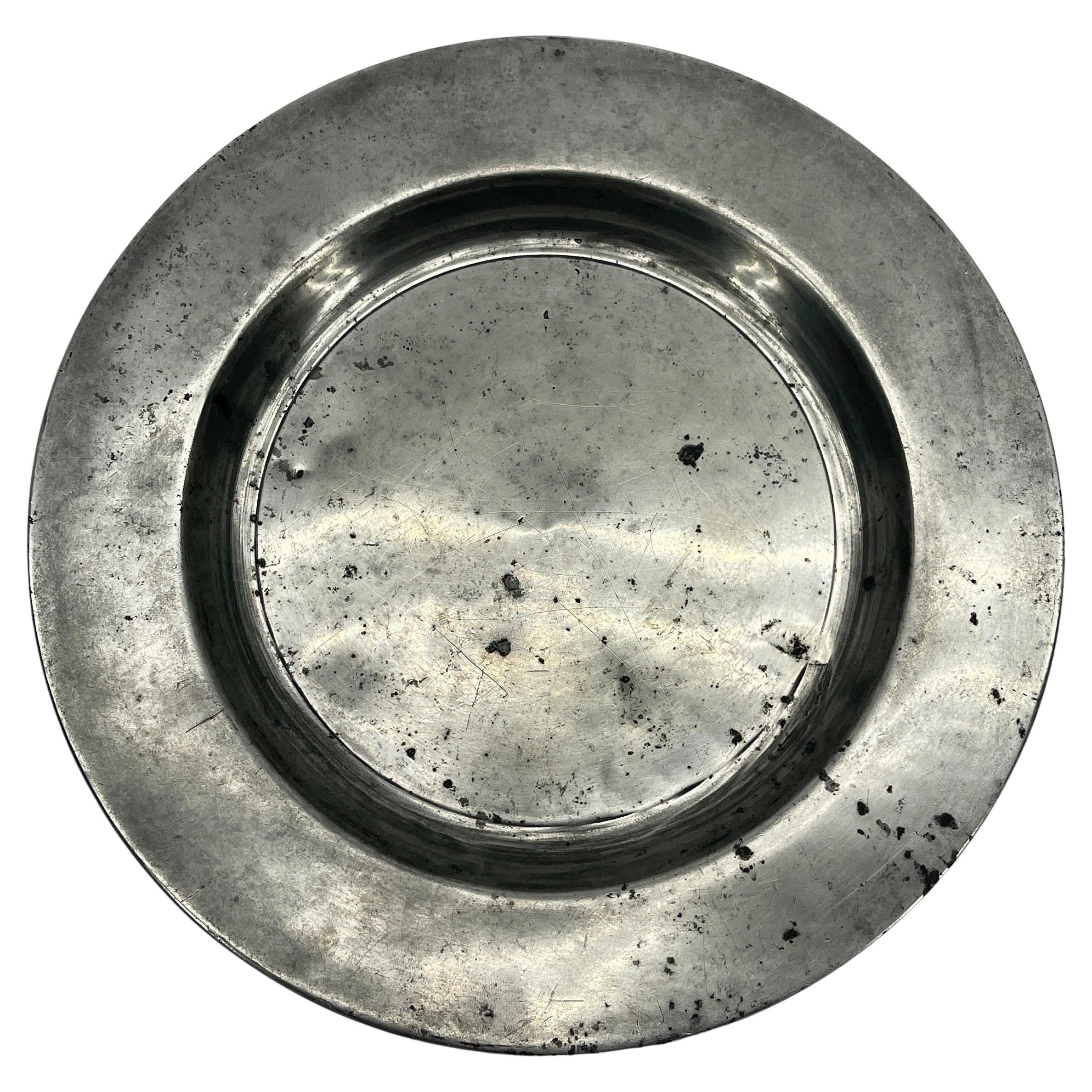 Small round pewter plate with London and makers mark on the rear side.