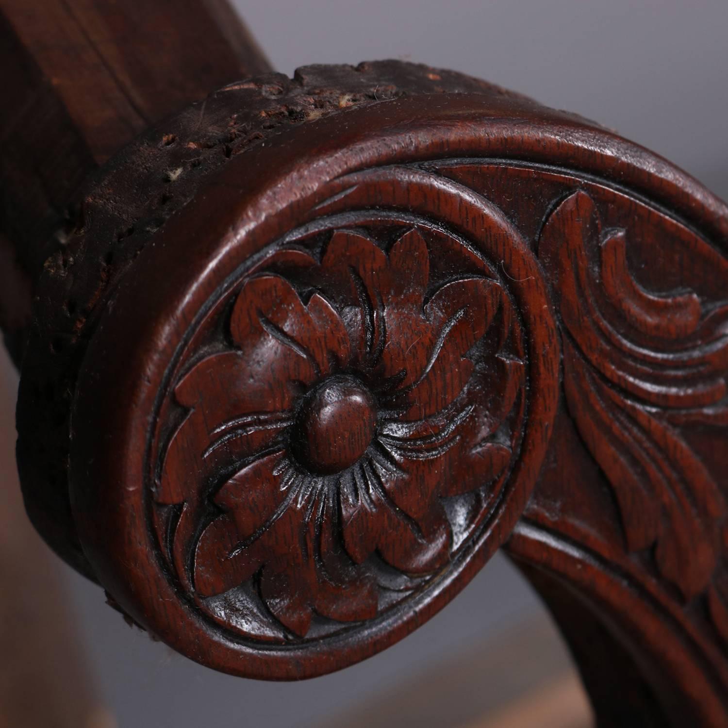 Early English Queen Anne settee frame features mahogany construction with camel back, scroll arms having carved floral rosettes and with foliate and scroll facing, seated on cabriole legs with foliate carved knees and feet, circa 1820.

Measures: