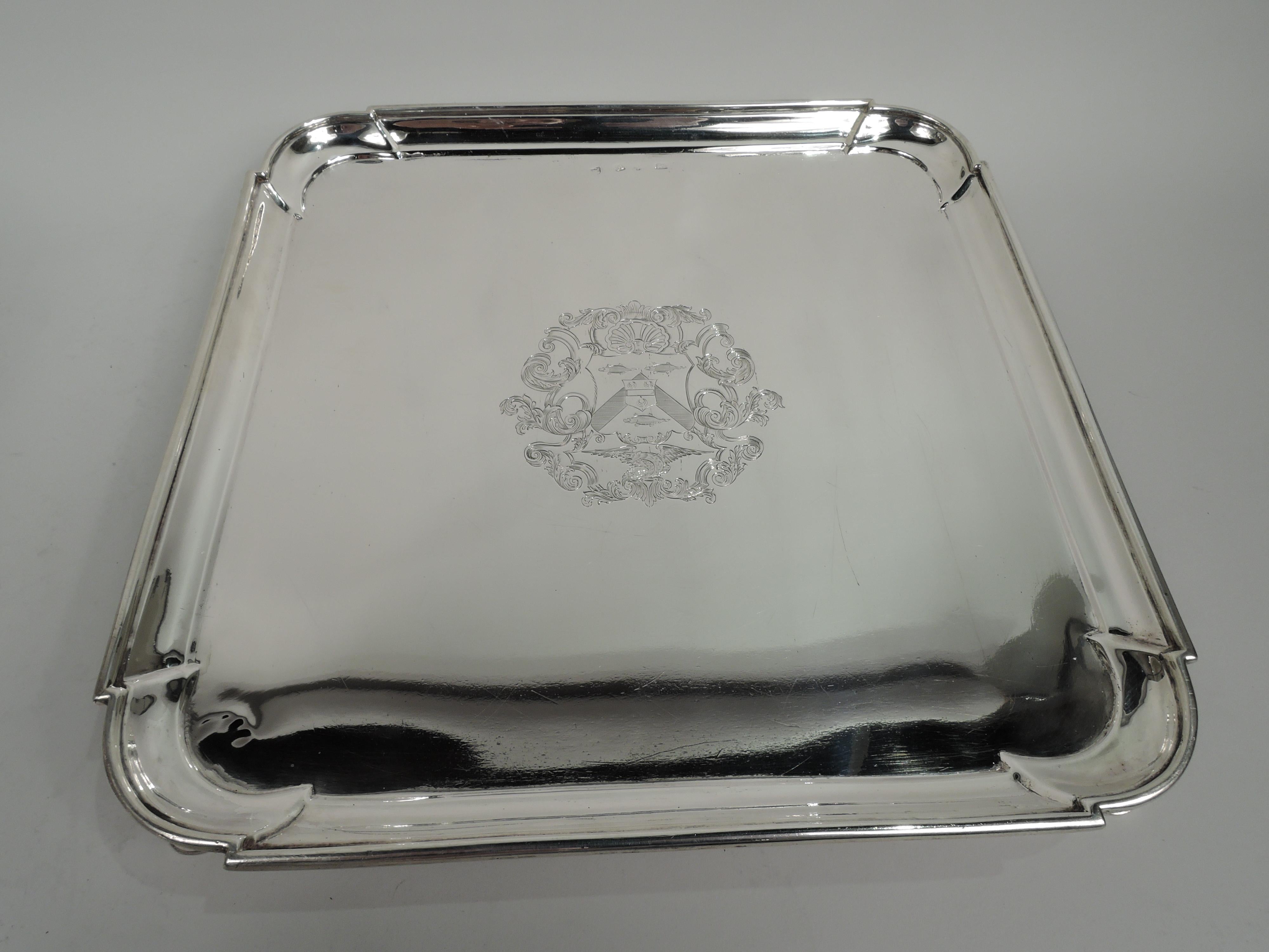 English Georgian sterling silver salver, 1727. Square with molded rim and curvilinear corners. Engraved armorial in well center. Rests on 4 corner hoof supports. Substantial with nice heft from the year the first Hanoverian king George I died and