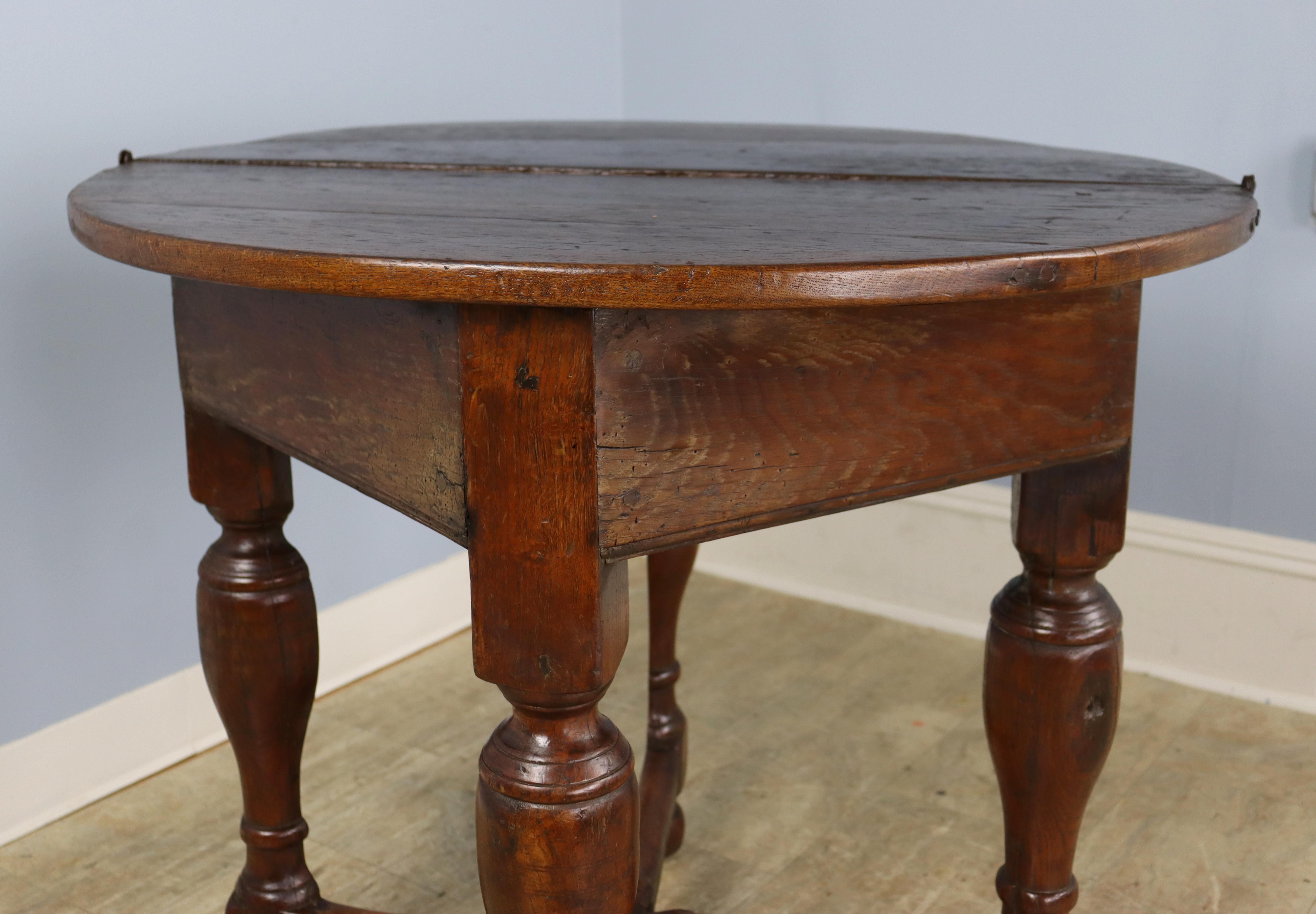 A credence table is a small side table in the sanctuary of a Christian church which is used in the celebration of the Eucharist. In this case, the table has been fashioned of dark lustrous oak and can be folded in to create a demi lune, suitable for