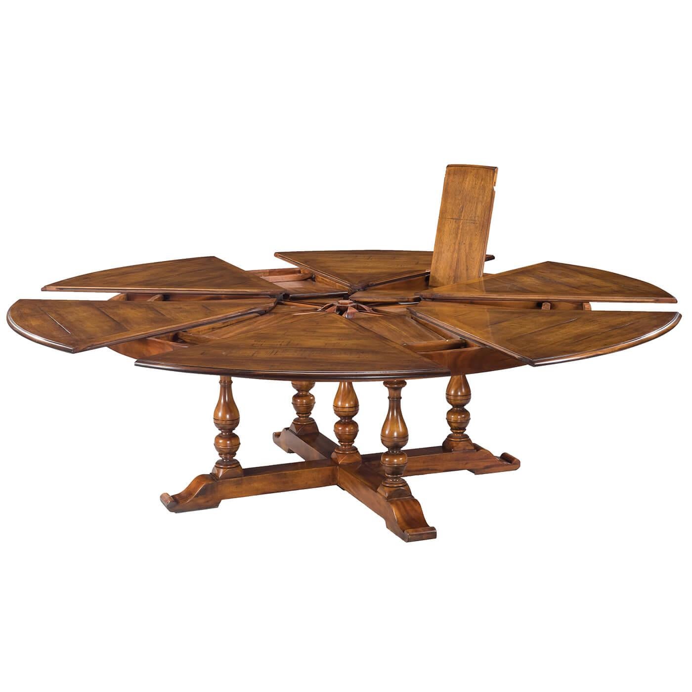 Early English style round extendable dining table. Walnut table is veneered in finely figured walnut segments and supported on four solid vase-shaped turned legs leading to the X form base.

Extra-large round size extends up to 100 inches with