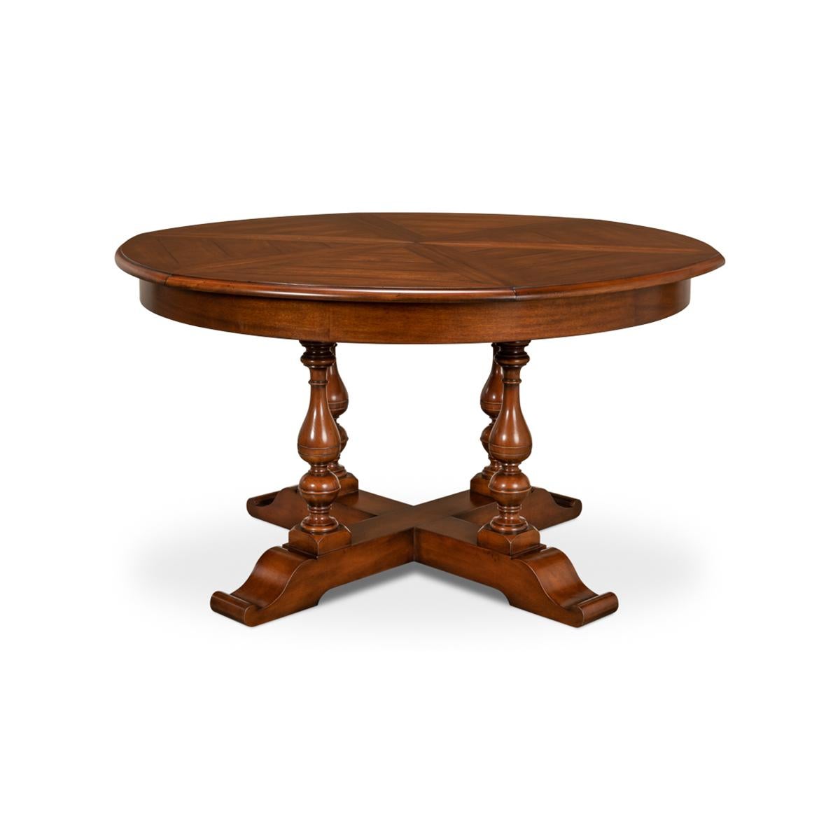 Early English style round extendable jupe dining table extending to 70 inches. Walnut table is veneered in finely figured walnut segments and supported on four solid vase-shaped turned legs leading to the X form base.

The table extends from 54 to