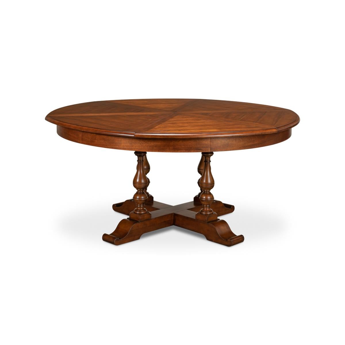 Early English style round extendable jupe dining table extending to 84 inches. Walnut table is veneered in finely figured walnut segments and supported on four solid vase-shaped turned legs leading to the X form base.

The table extends from 64 to