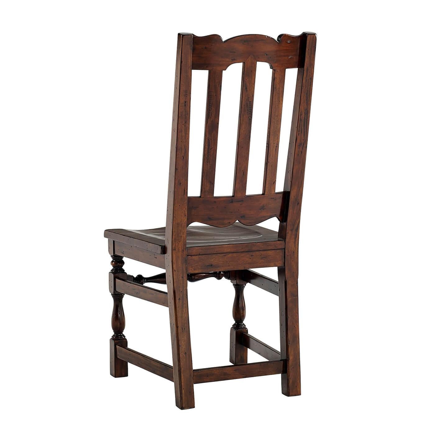 An early English Jacobean style antiqued wood side chair, the slatted back with an arched carved top rail, the solid seat on turned legs joined by stretchers. 

Dimensions: 19