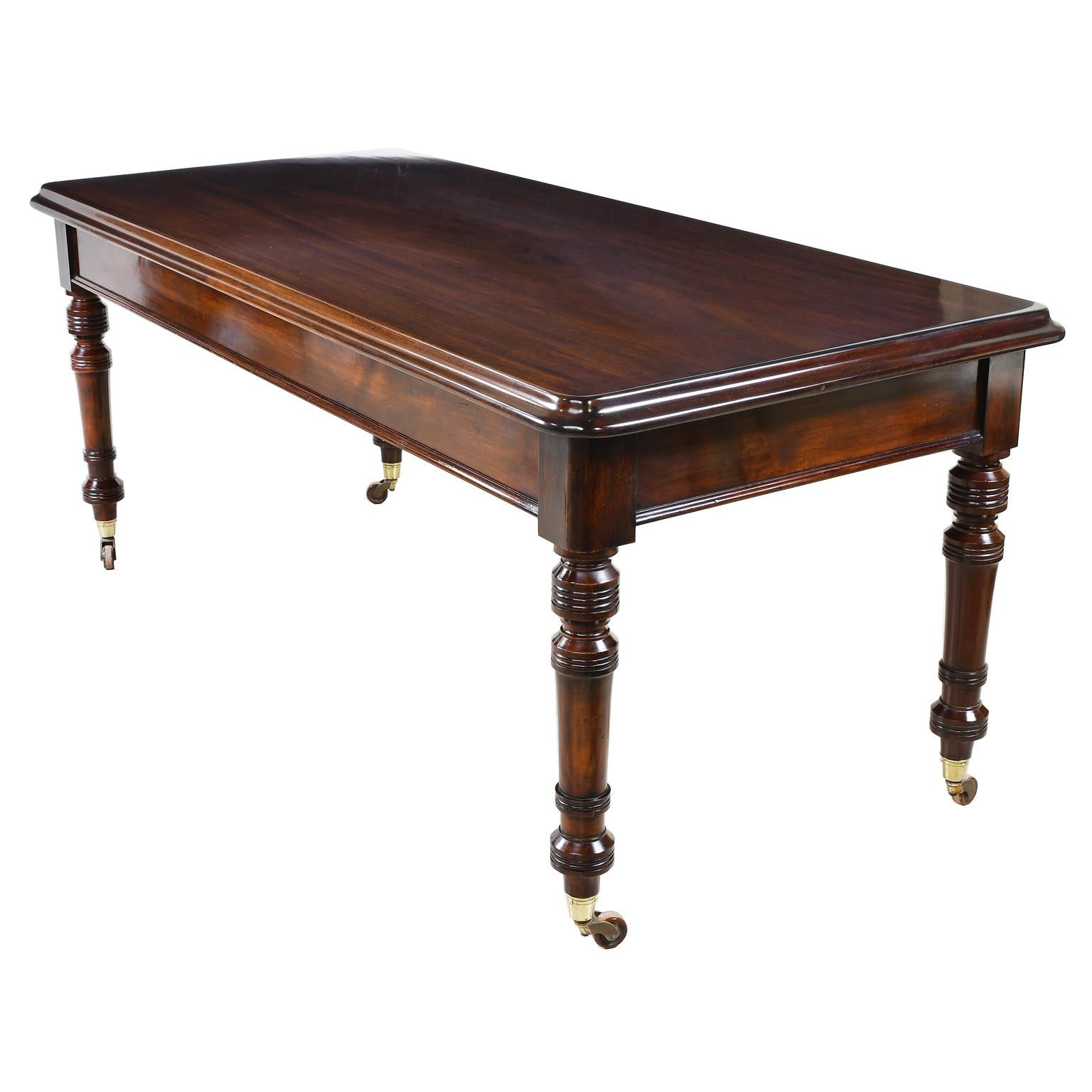 Elegant with a contemporary line this early Victorian or late William IV mahogany library table, circa 1840 has an understated elegance. The crisply turned legs, basic apron and deep ogee edge in the thick mahogany top all lend to its pleasing