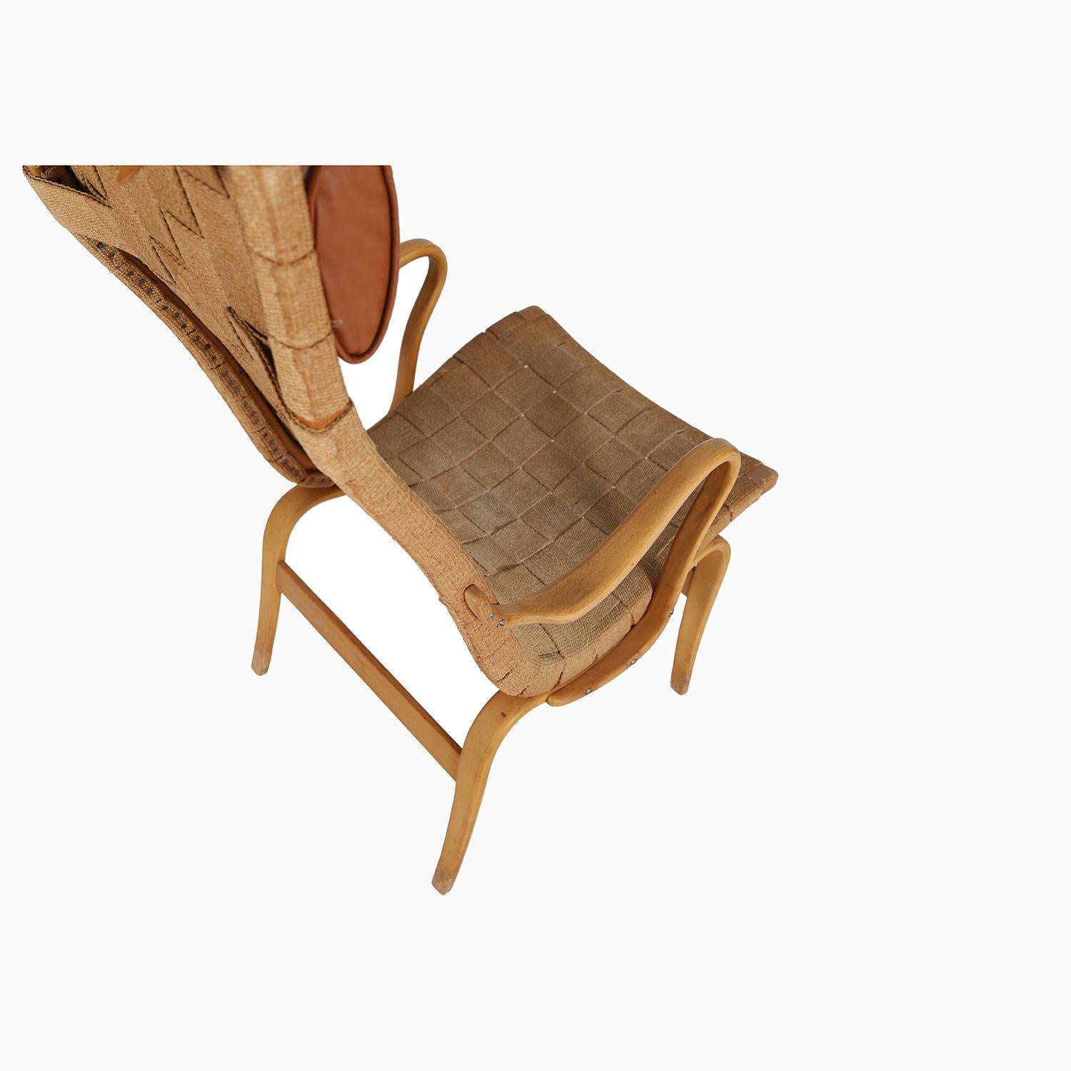 


This lovely chair was designed by Bruno Mathsson for Karl Mathsson.  Patinated beechwood frame and original natural fiber webbing.  Linen head pillow with leather trimmings has some wear and losses along the top-- this pillow could be updated