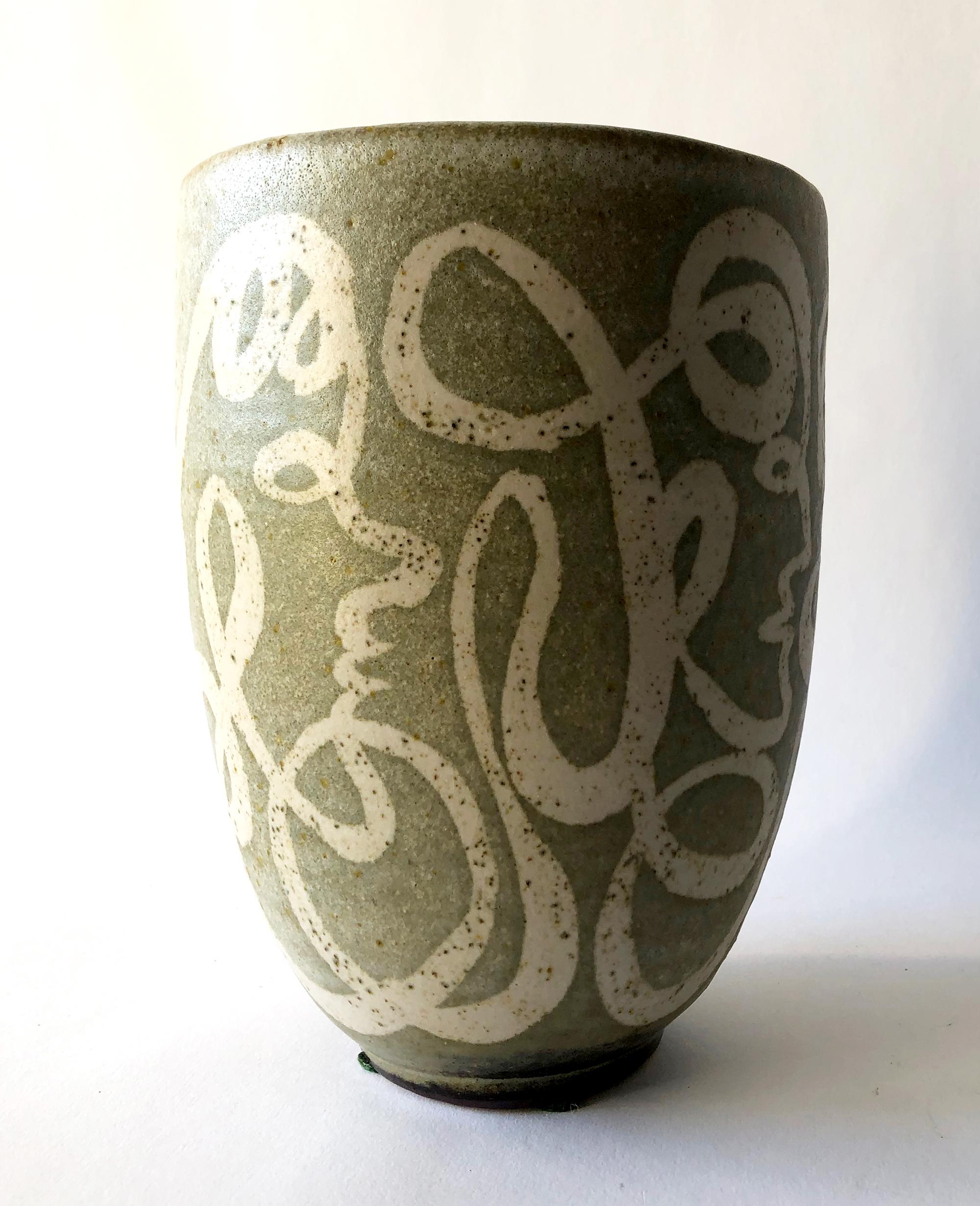 A rare example of late 1940s or early 1950s ceramic pot vase created by the husband wife team, Ernst and Alma Lorenzen of Nova Scotia. Pot depicts hand drawn etherial faces which reminds one of Jean Cocteau's mythological work. Piece measures 7.25